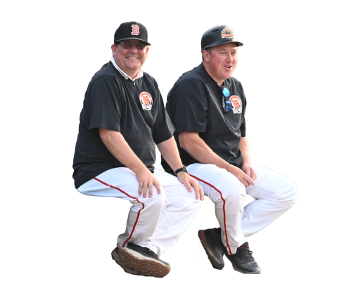 Two men in baseball uniforms sitting side by side, smiling, with a black background.