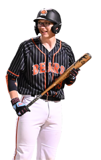 A female softball player in a black and orange Chicago Bears jersey, white pants, black helmet, and glasses, holding a bat and smiling.