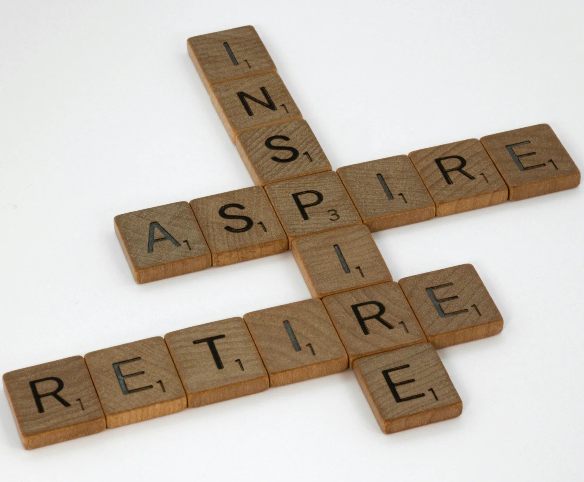Scrabble tiles spelling out the word 'INSERT' on a white background.