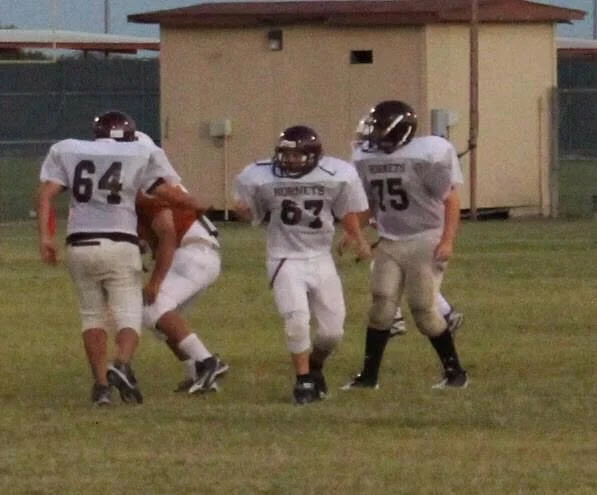 My boys playing football during their childhood.