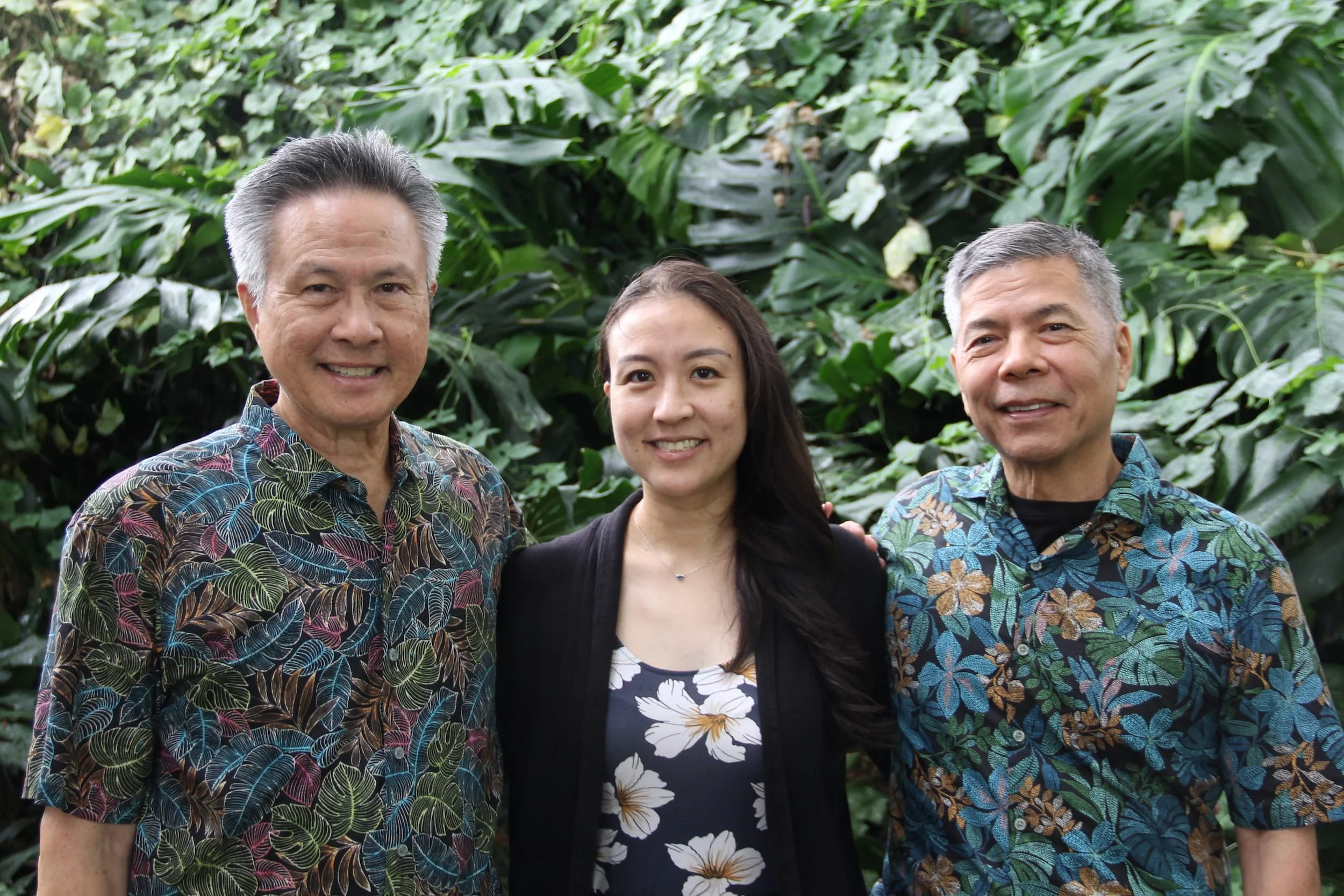 Arthur Lum, Lauren Lum, and Randall Fukuji standing outdoors at Fukuji and Lum Physical Therapy.
