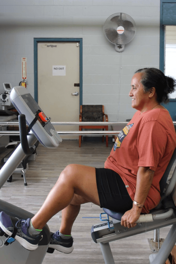 A patient dressed in comfortable clothing ready for a physical therapy session.