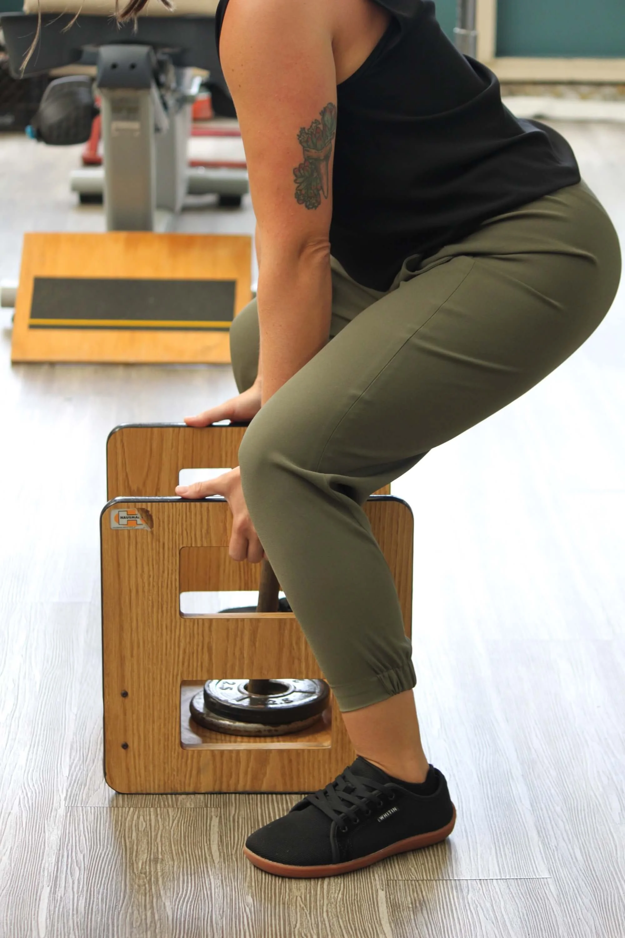 A patient rebuilds lifting strength on a weighted lift box during occupational rehab at Fukuji & Lum's W.O.R.C. center.