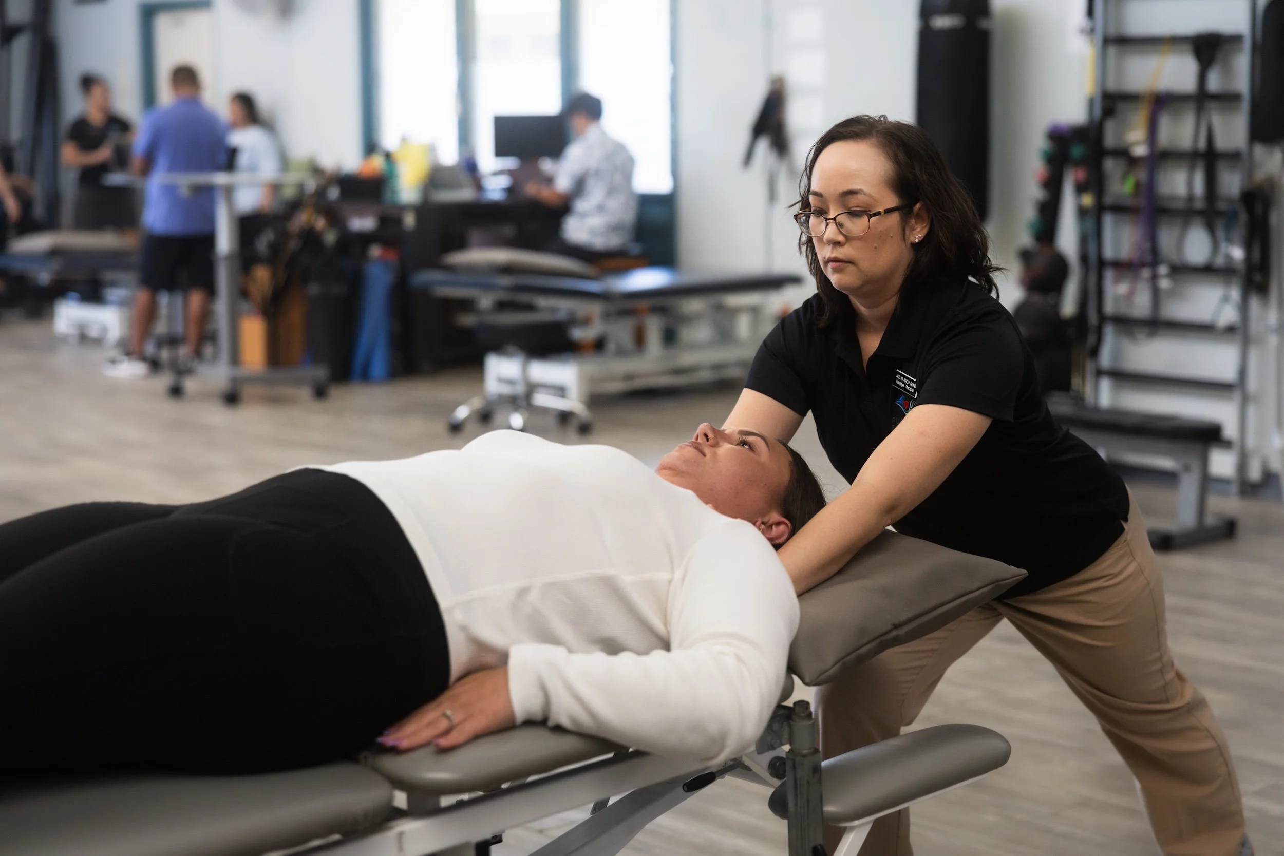 A massage therapist uses myofascial release techniques to ease muscle tension.