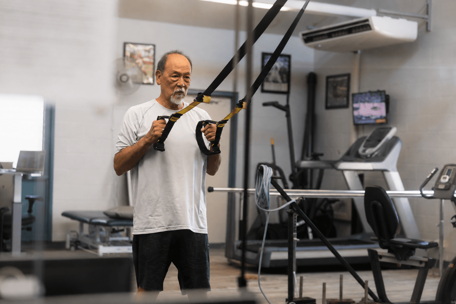 A patient performs a TRX resistance exercise during an occupational rehab session at the W.O.R.C. gym.