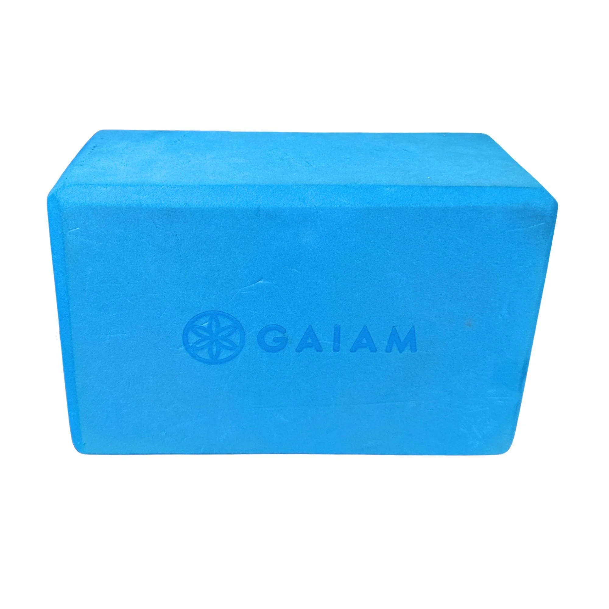 A blue Gaiam yoga block for support and stability during exercises.