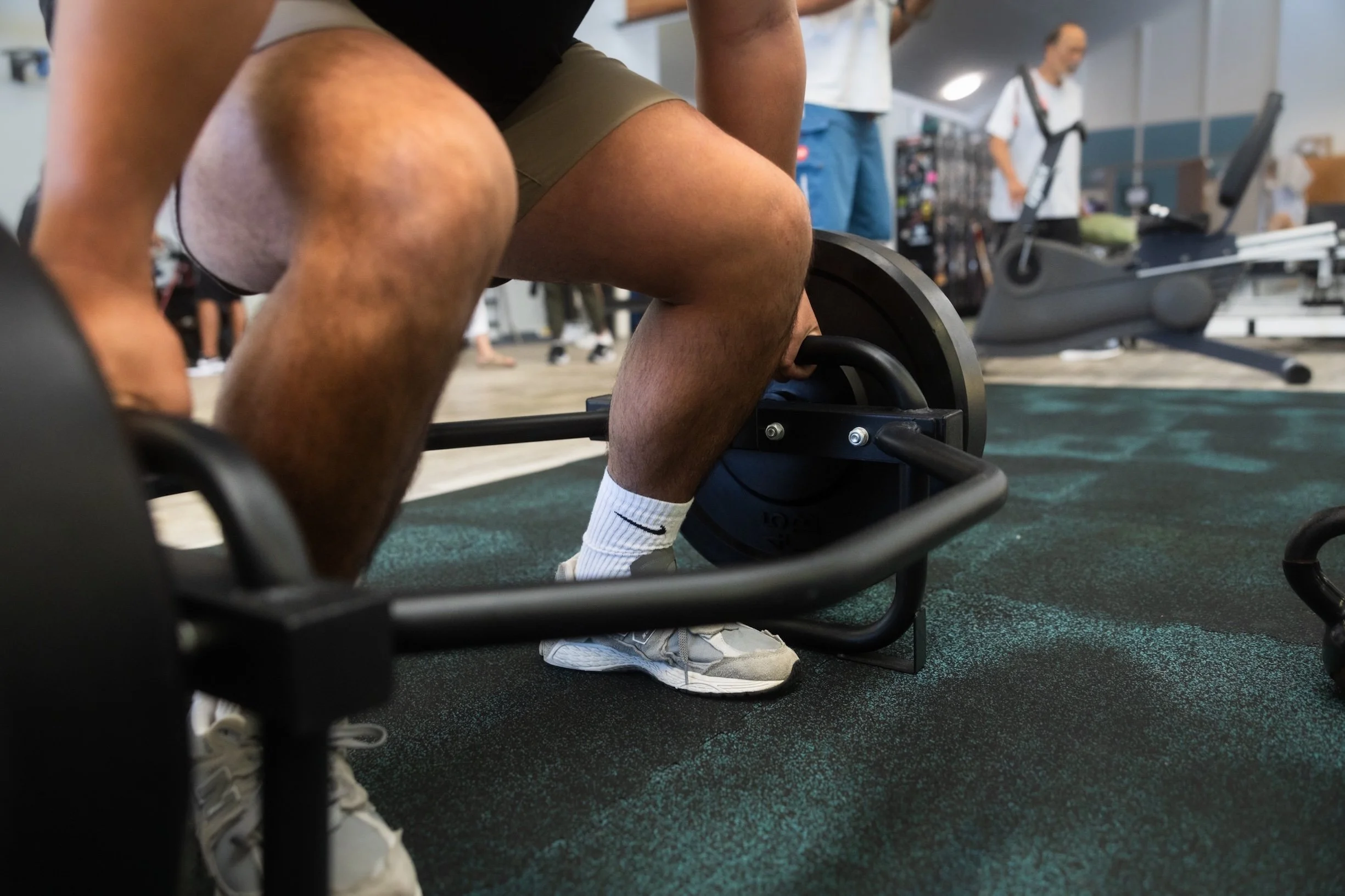 A patient performs a weighted lower-body strengthening exercise during occupational rehab at Fukuji & Lum's W.O.R.C. center.