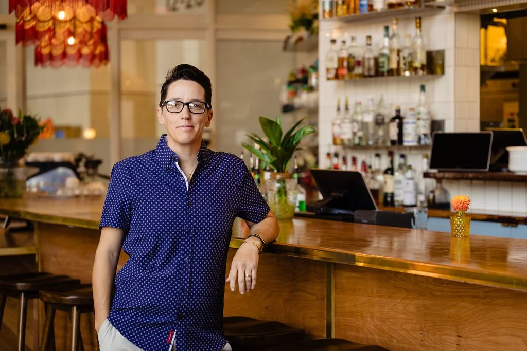 Restaurant owner posing at bar