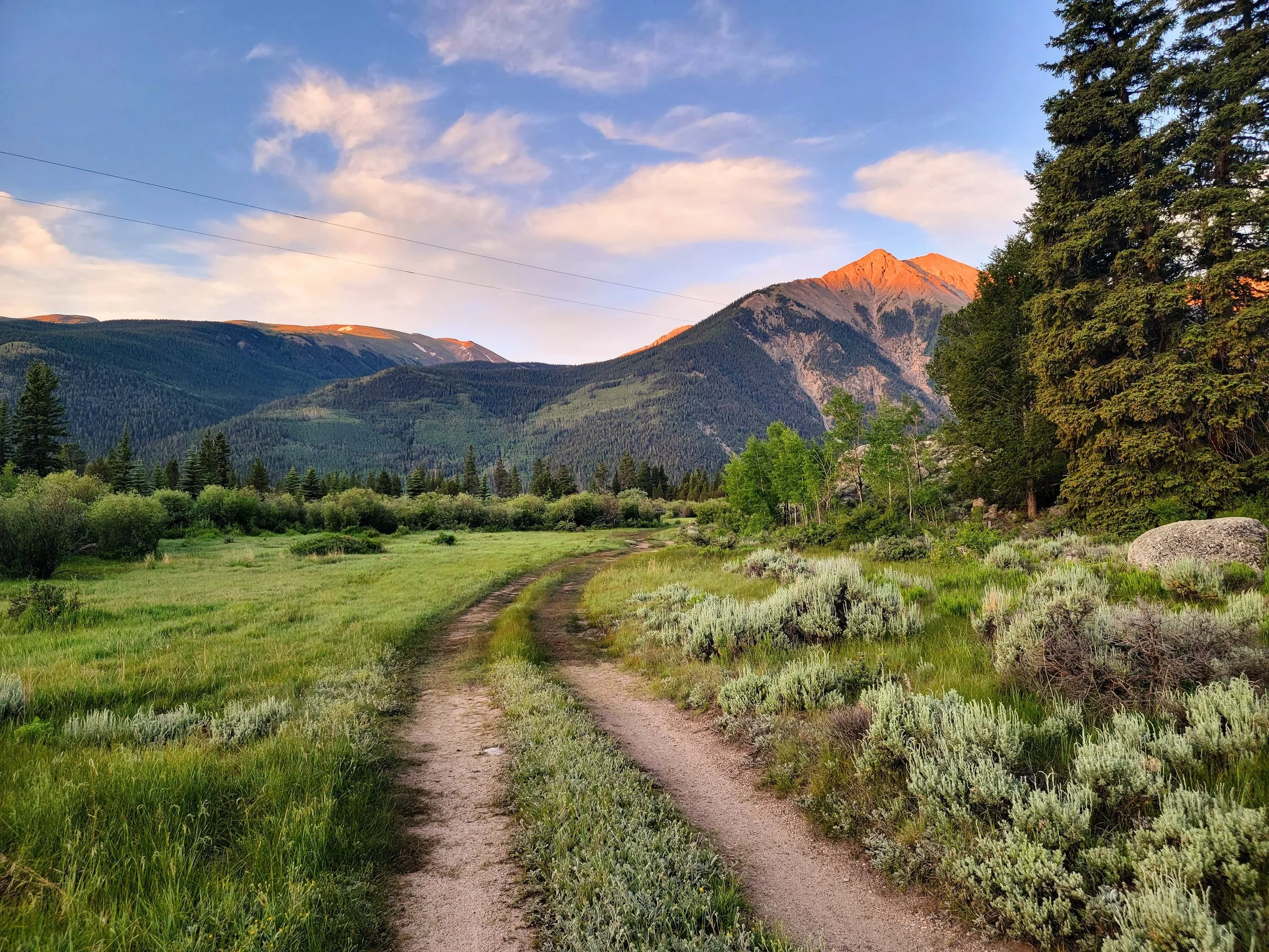 A mountain path at golden hour representing the healing journey at Ethereal Flow Acupuncture in Colorado Springs