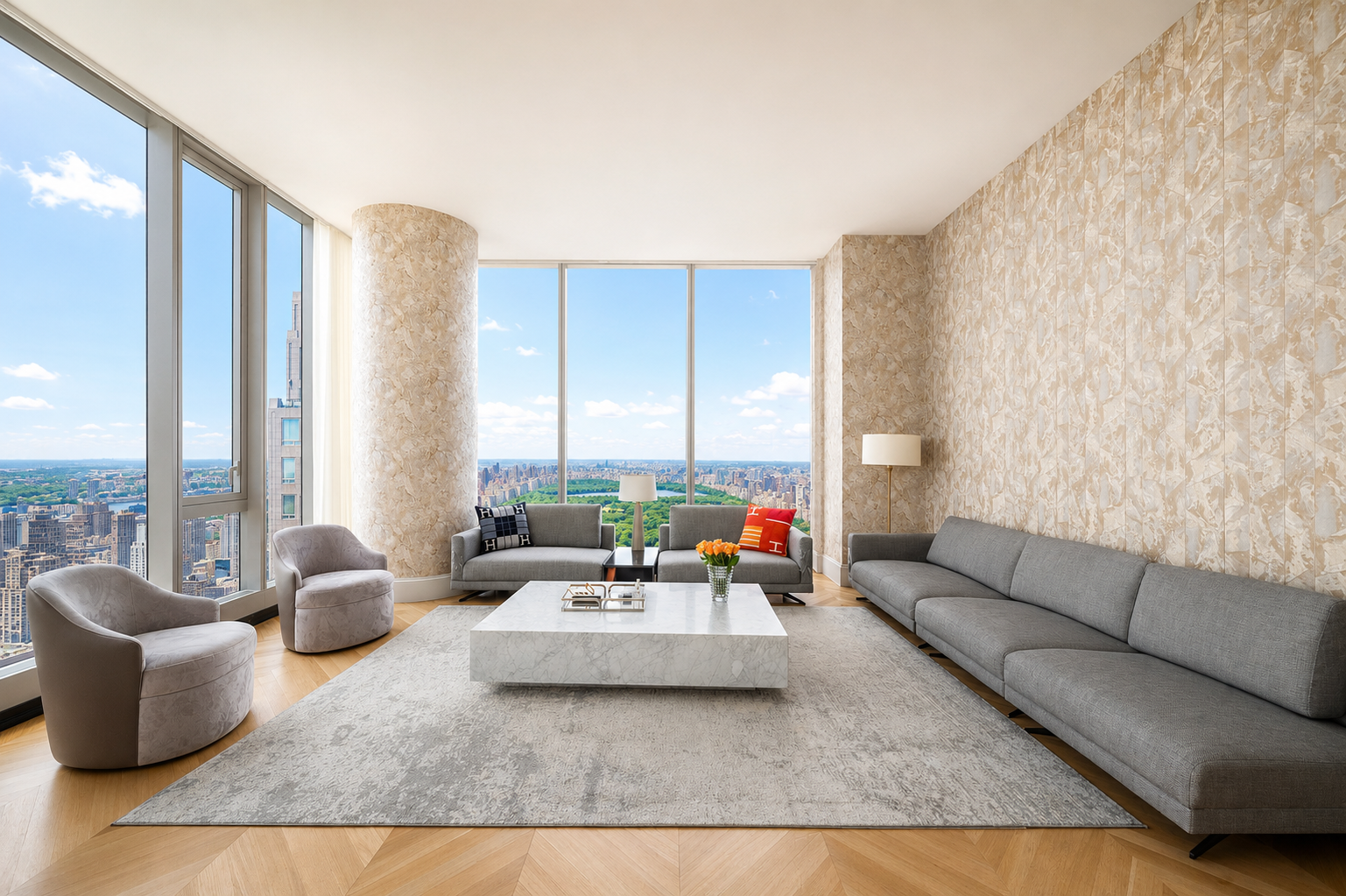 Modern living room with large floor-to-ceiling windows, overlooking a city skyline and central park, furnished with gray sofas, two armchairs, a white marble coffee table, and contemporary lamps.