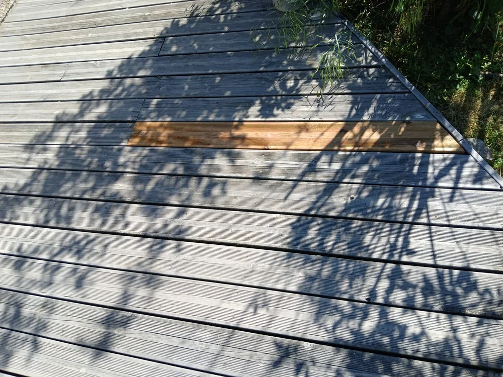 Un plancher en bois avec une planche en bois plus foncée au centre.
