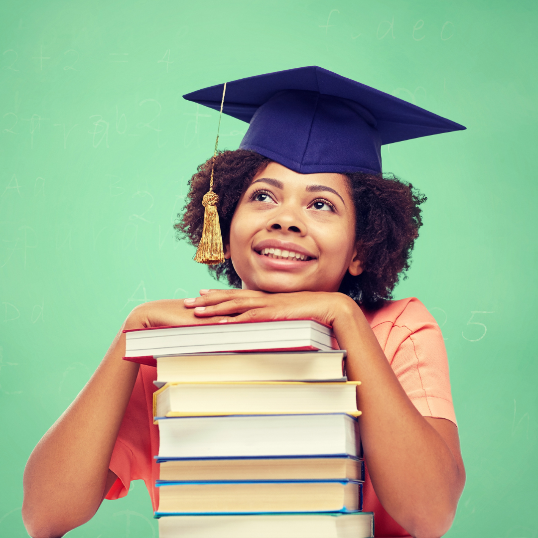 A black/African girl with books and a graduation hat.