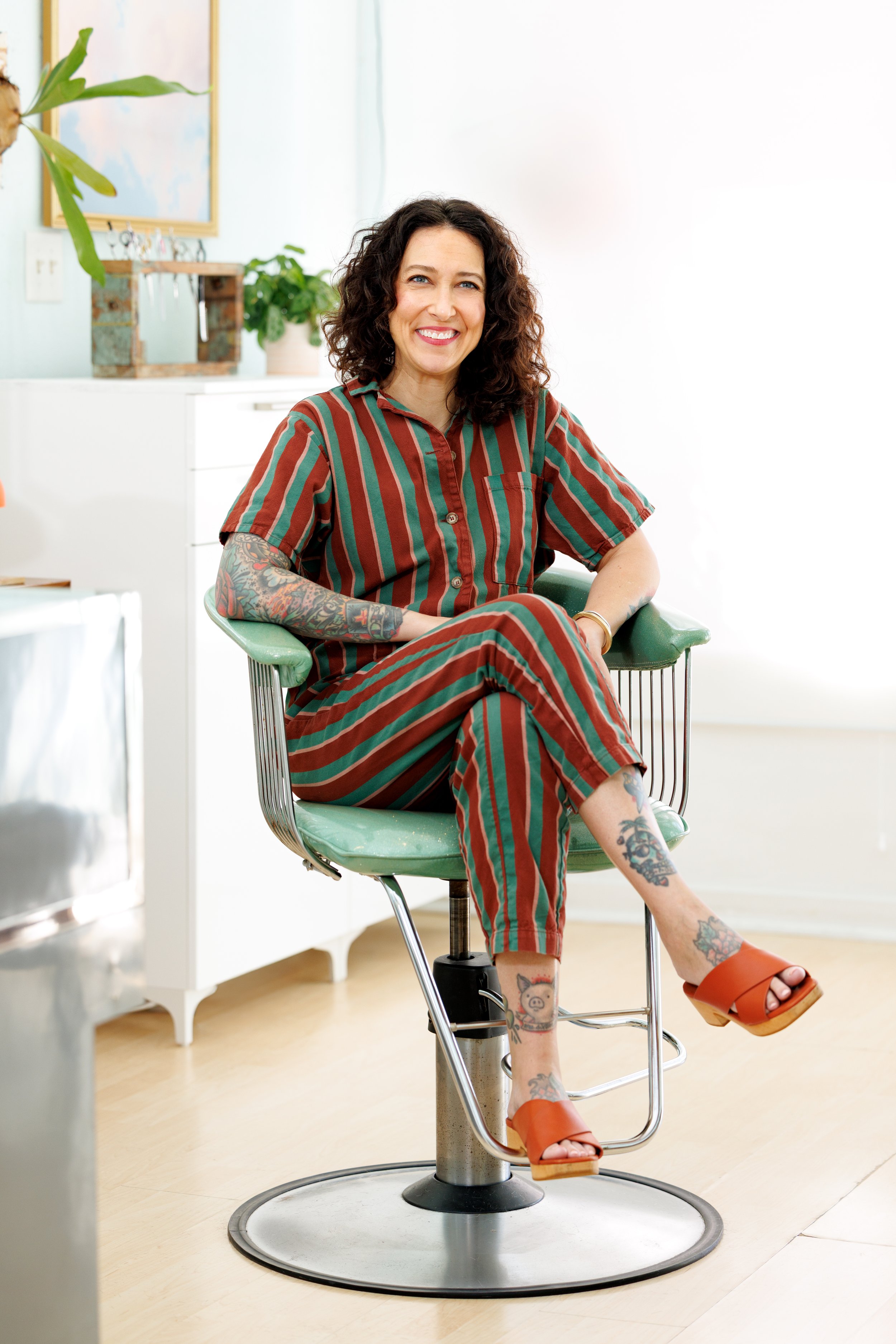Hair stylist sitting in chair in salon