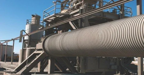 Industrial piping and metal structure in an outdoor factory setting.