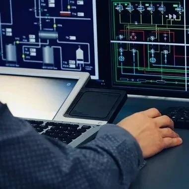 Person working on a computer with multiple electronic circuit schematic diagrams on screens.