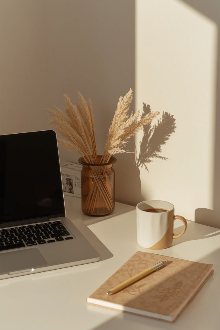 Laptop with coffee and notebook