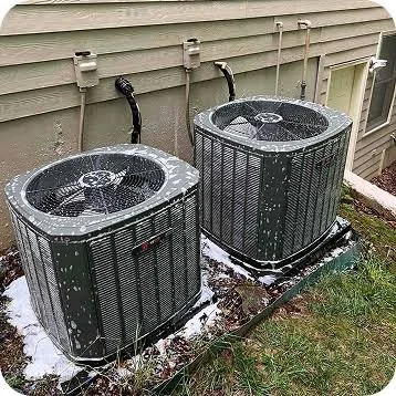 HVAC technician servicing an outdoor air conditioning unit in Morganton, NC