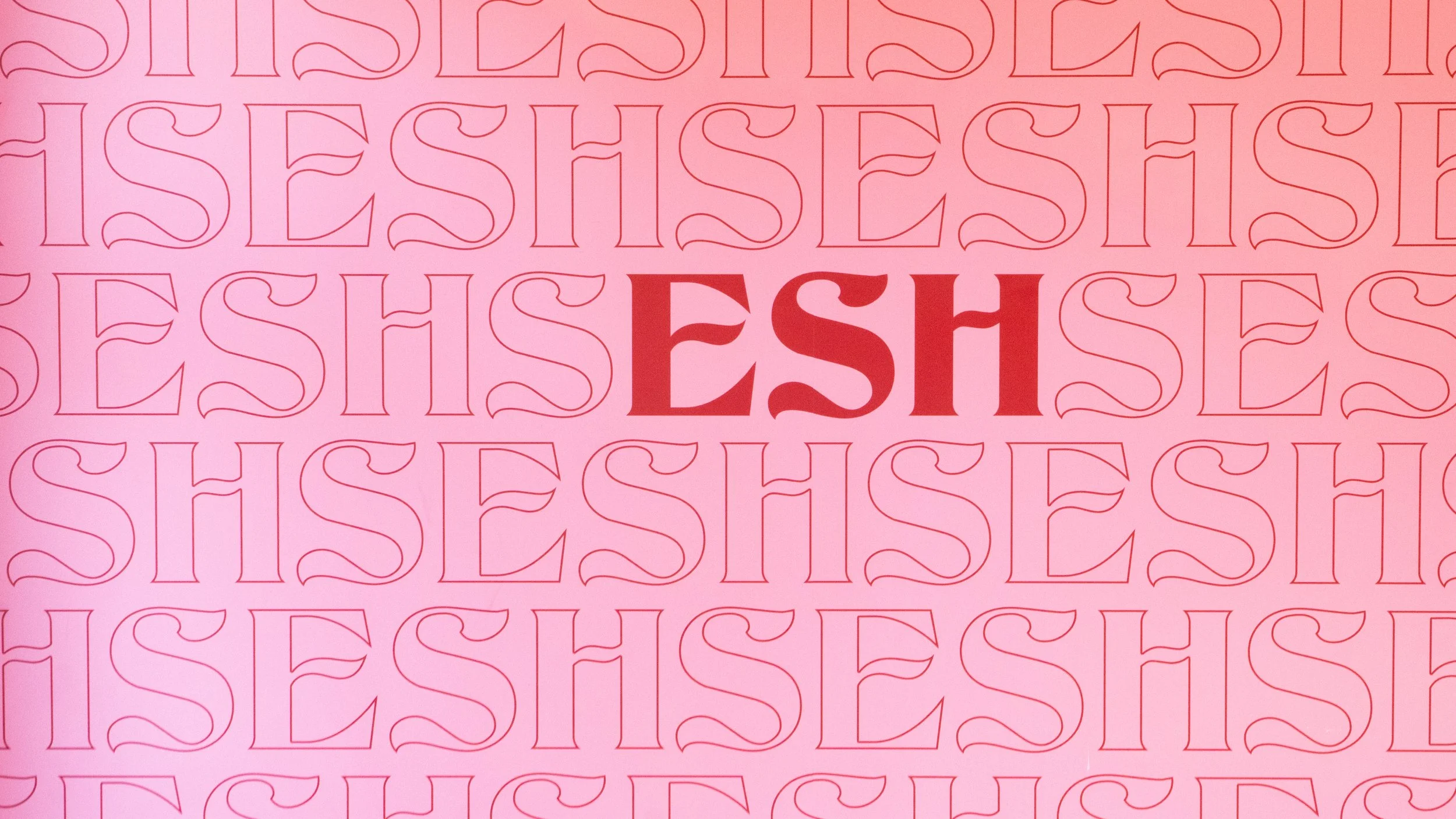 Pink background with repeated outline text that spells 'FRESH' in a stylized font. In the center, the word 'FRESH' is written in bold, red, uppercase letters.