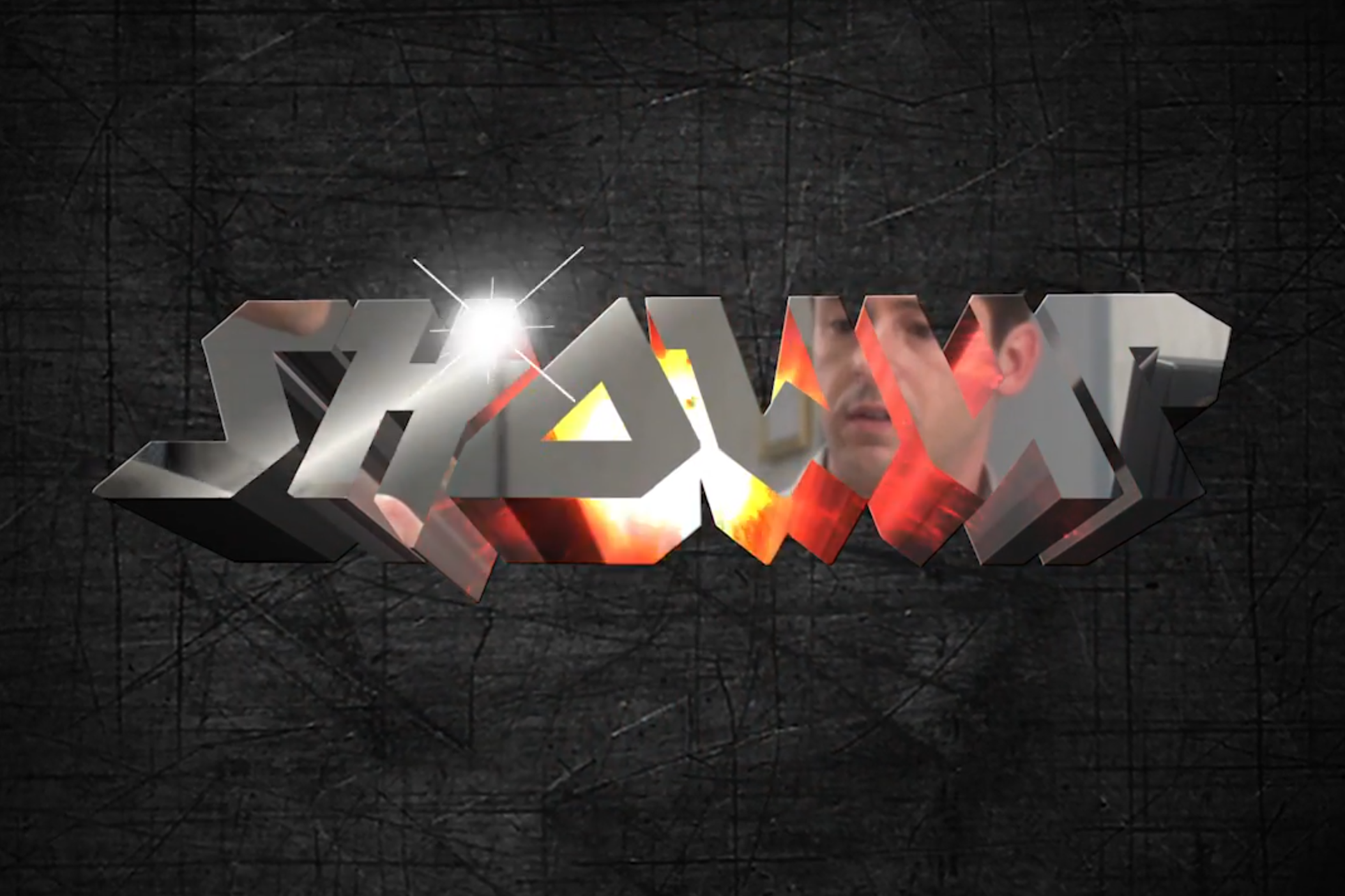 3D metallic text displaying the word "SHOWUP" with a man’s face reflected in the letters, set against a dark textured background.