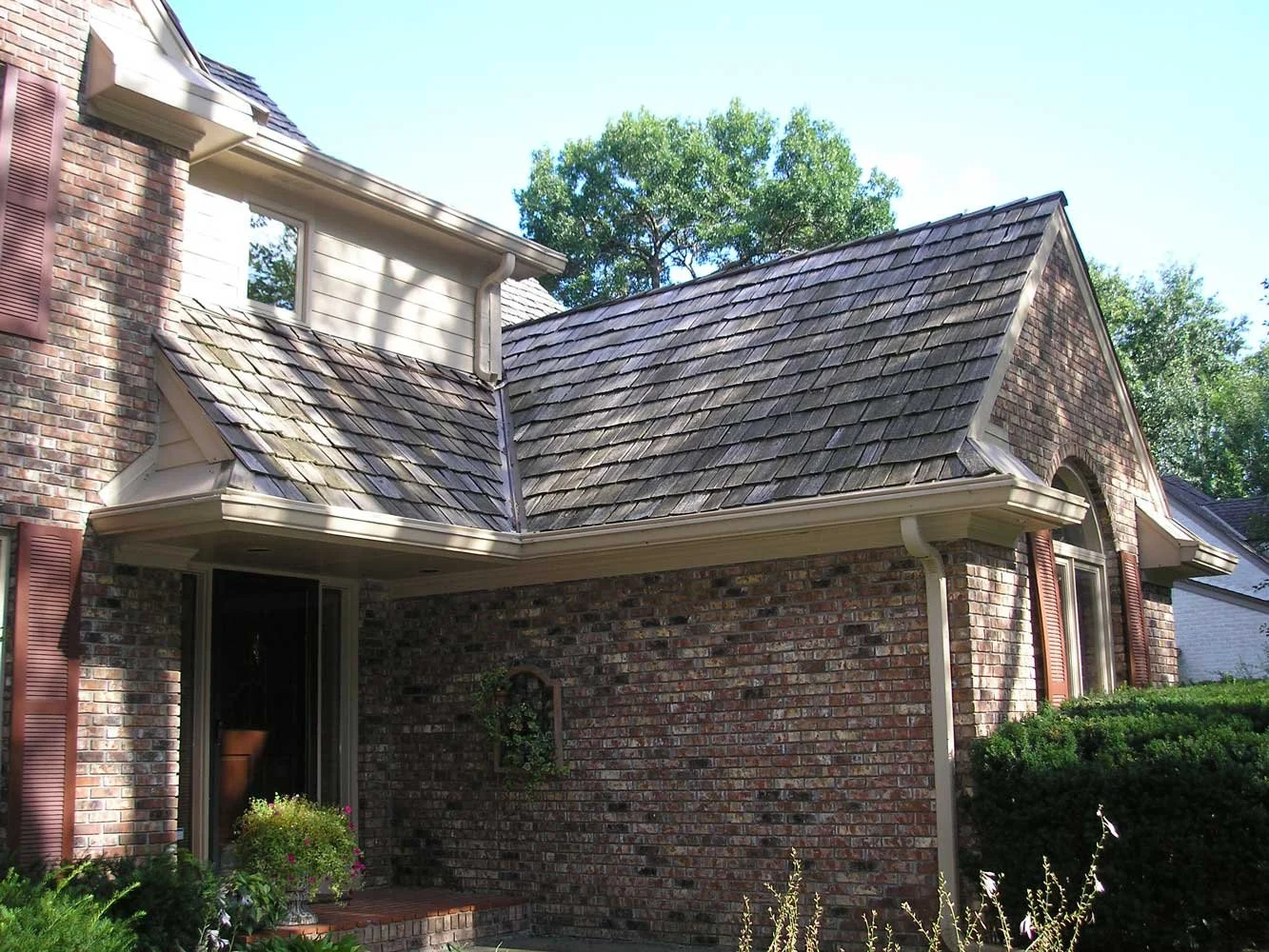 Brick home with Leaf Sentry installed and protecting the gutters