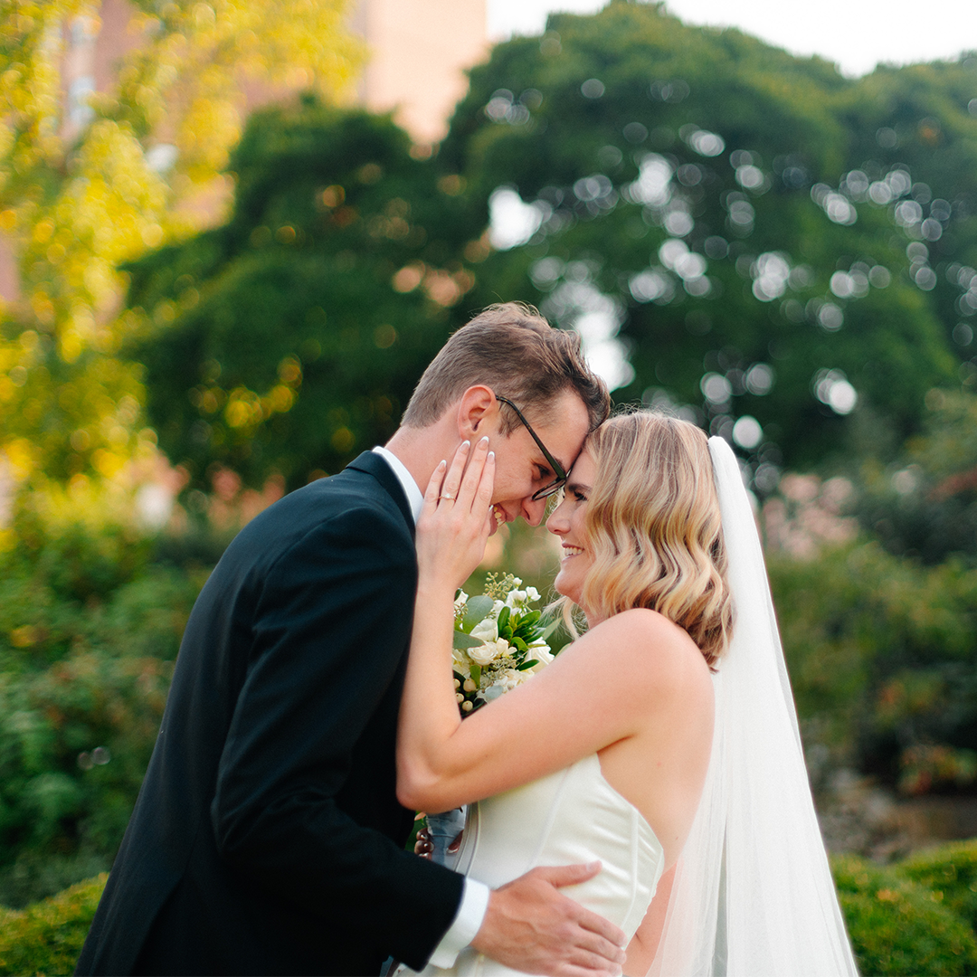 Studio Merv photographs a wedding portrait of a smiling groom and bride embracing each other in Missouri