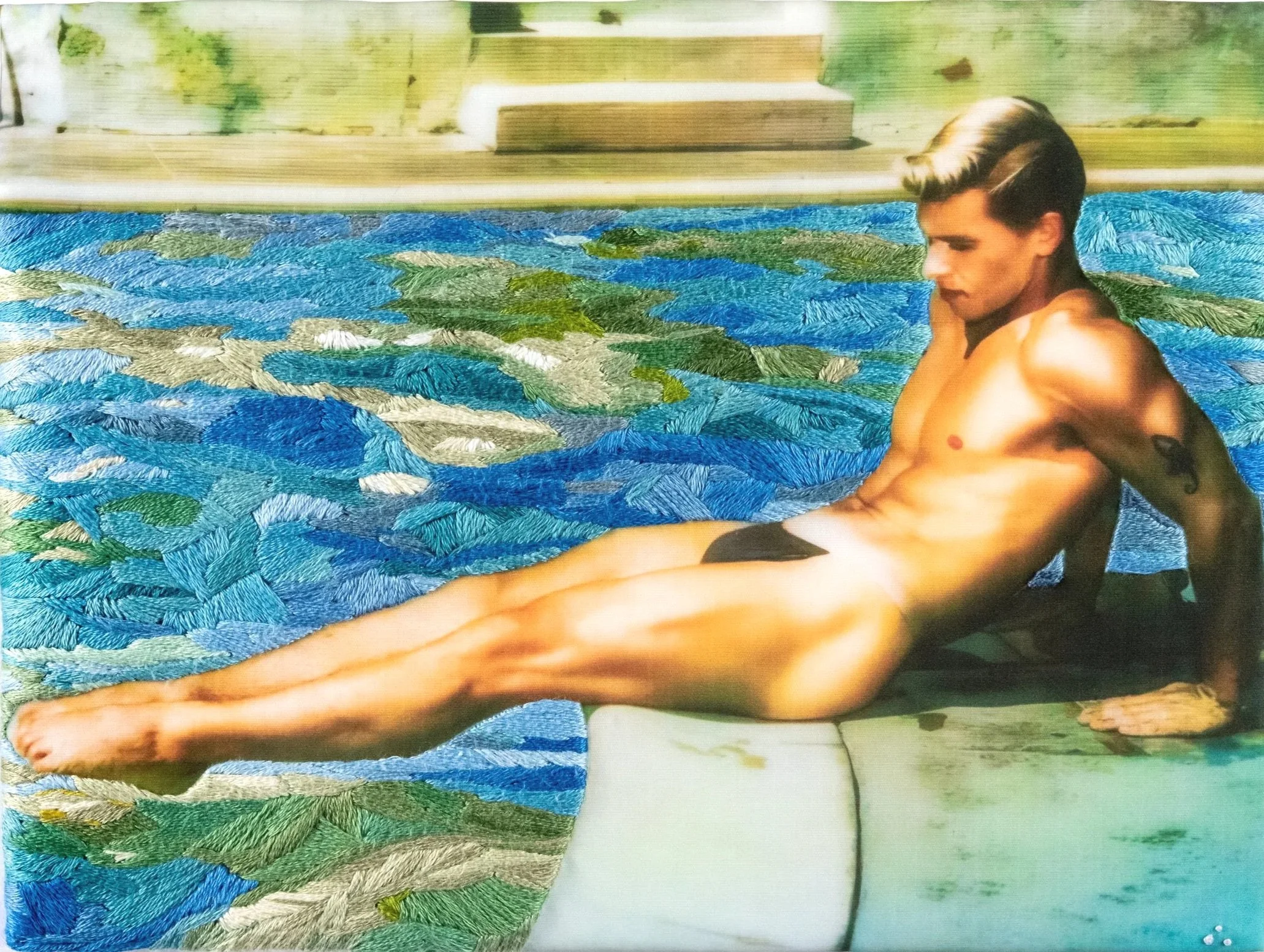 A man with styled hair relaxing in a swimming pool surrounded by a backyard with wooden steps and greenery.
