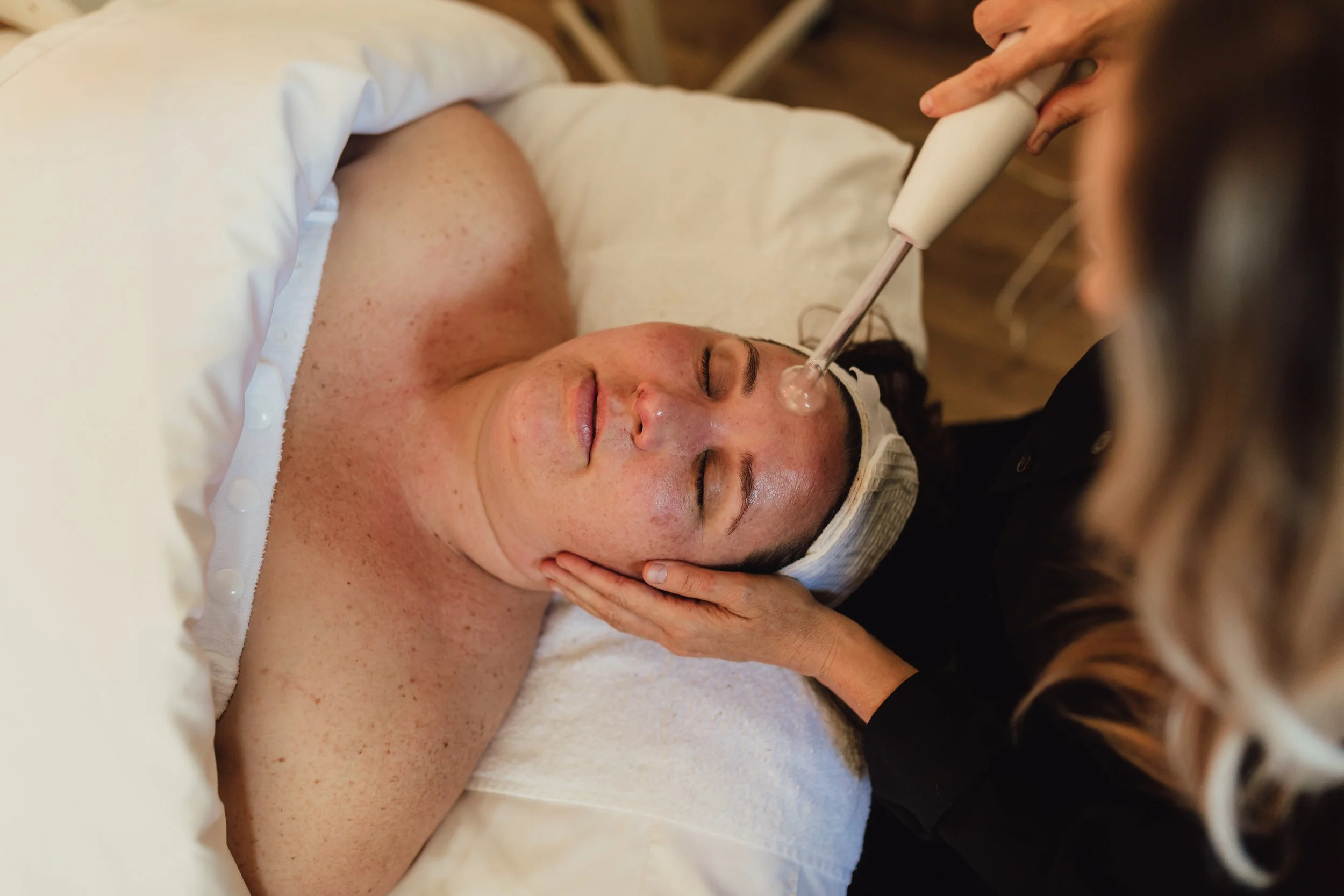 Client recieving advanced luxury facial skincare treatment at wellness spa