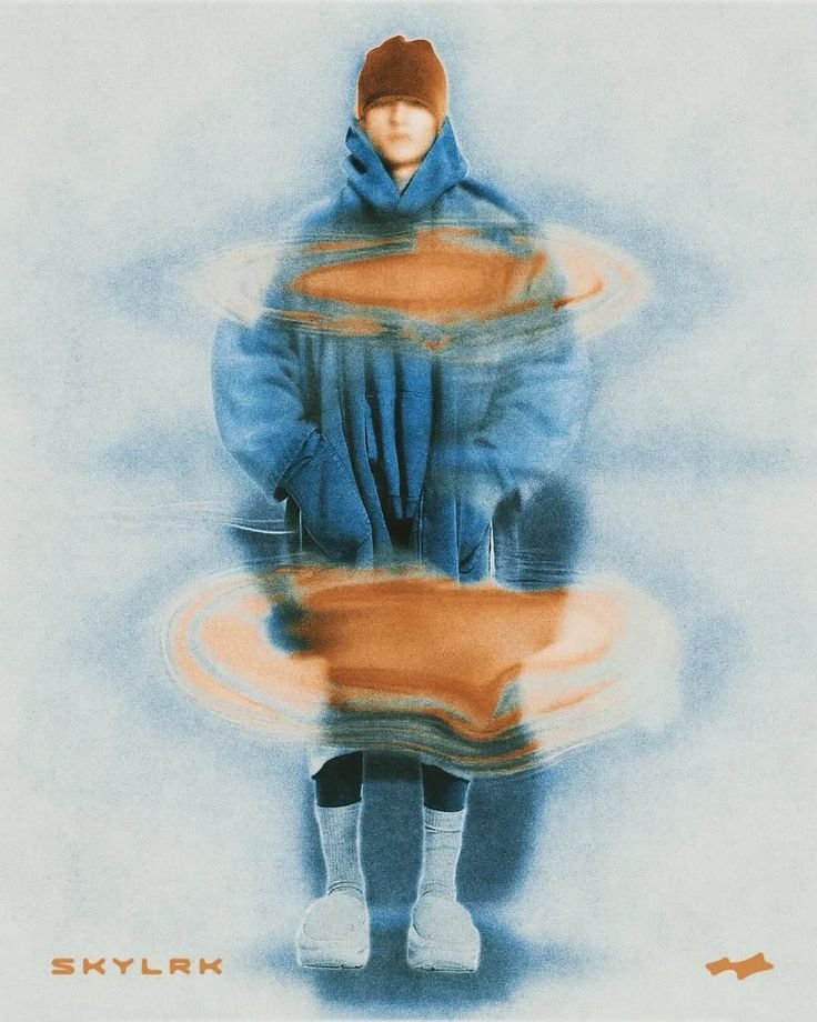 A person wearing a brown beanie, blue jacket, shorts, and socks stands against a blue background. The image has a water ripple effect distortions around the person, creating a surreal appearance. The word "SKYLARK" appears in orange text at the botto