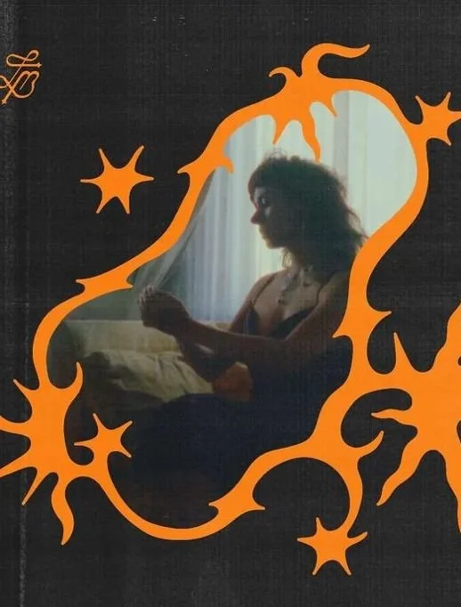 A person sitting in front of a mirror with an orange flame-like border around the reflection.