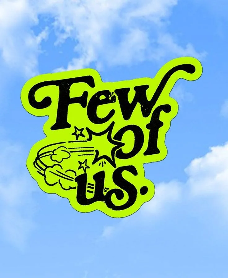 A green sticker with the words 'Few U.S.' written in black, colored with a yellowish-green outline, and an illustration of a cloud with stars and motion lines, set against a blue sky with some white clouds.