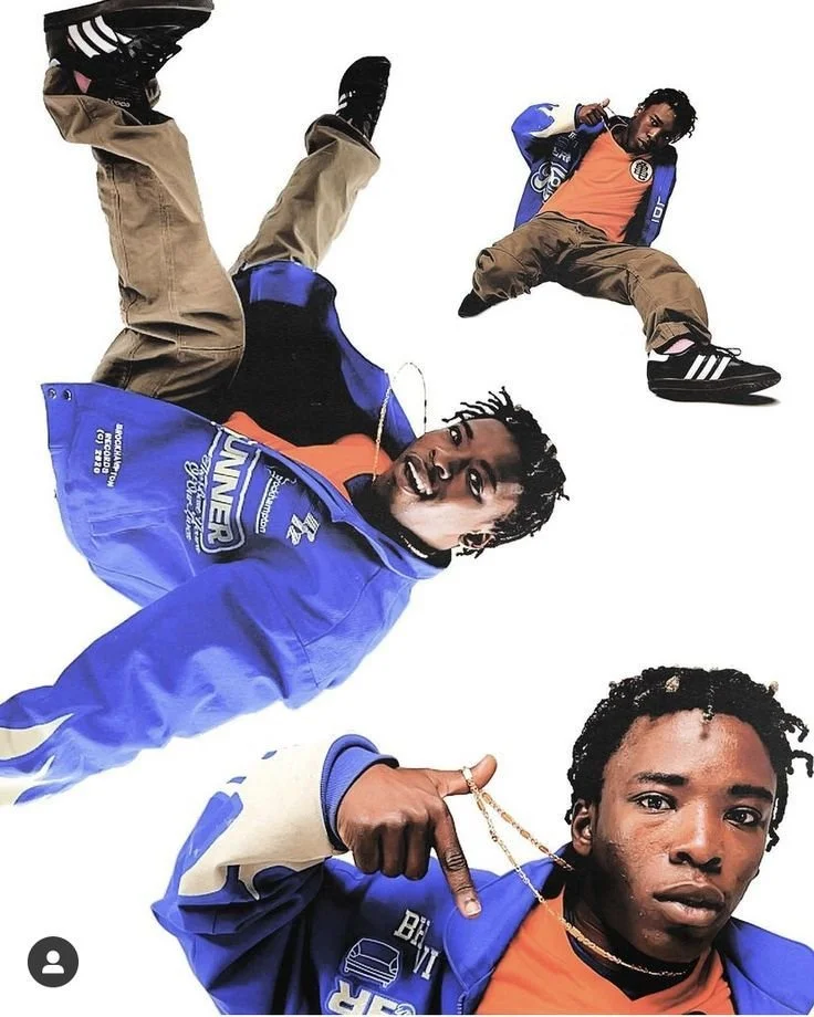 Three young men dressed in streetwear, with two wearing blue and one in an orange shirt, posing against a plain white background.