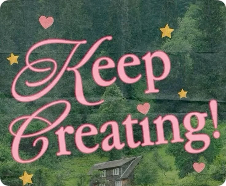Decorative sign with the words 'Keep Creating!' in pink lettering, surrounded by small pink hearts and yellow stars, set against a background of green trees and a house.