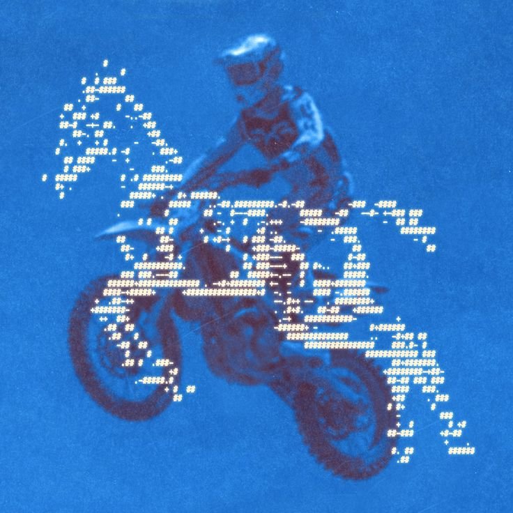 Pixelated image of a person performing a stunt on a motorcycle against a blue background.