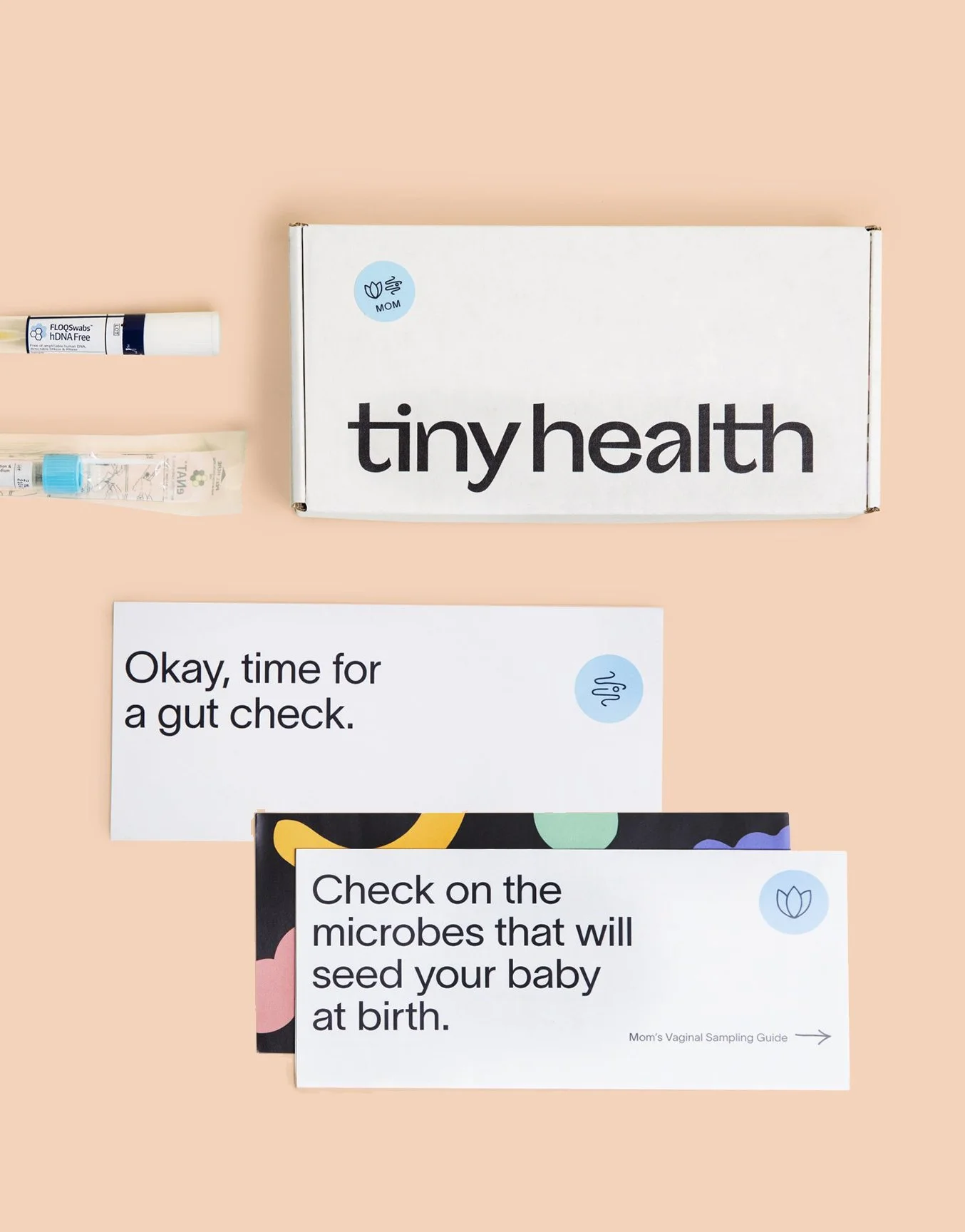 A Tiny Health home testing kit with a box titled 'tiny health' and instructional papers about gut health and microbiomes, along with sample collection tubes.