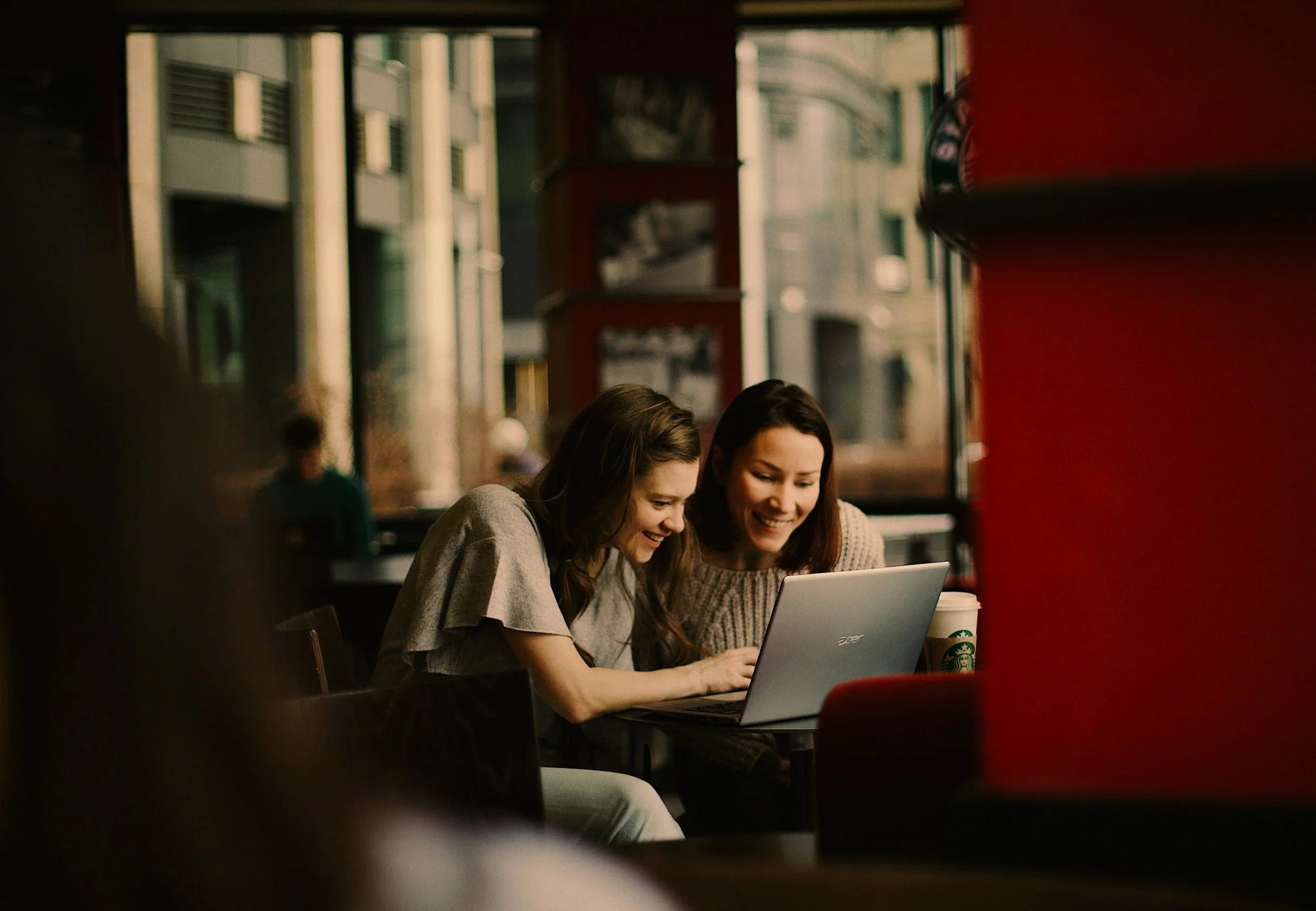 Consultant and client collaborating on a laptop