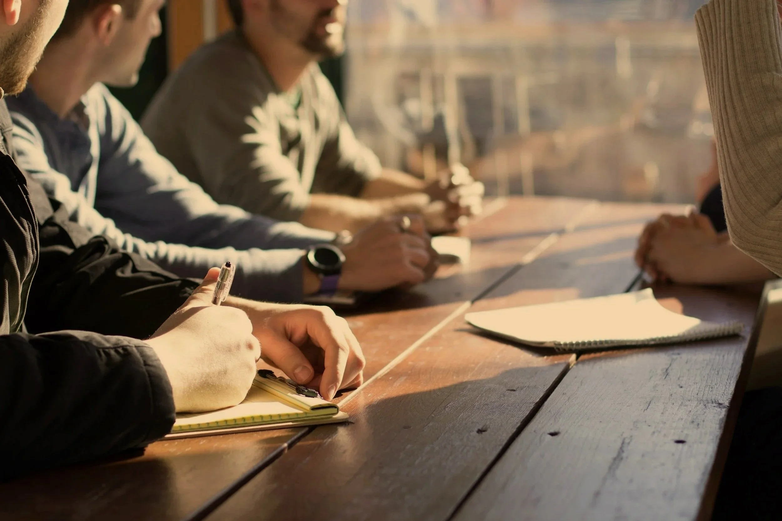 Business consultants reviewing plans with a client at a conference table