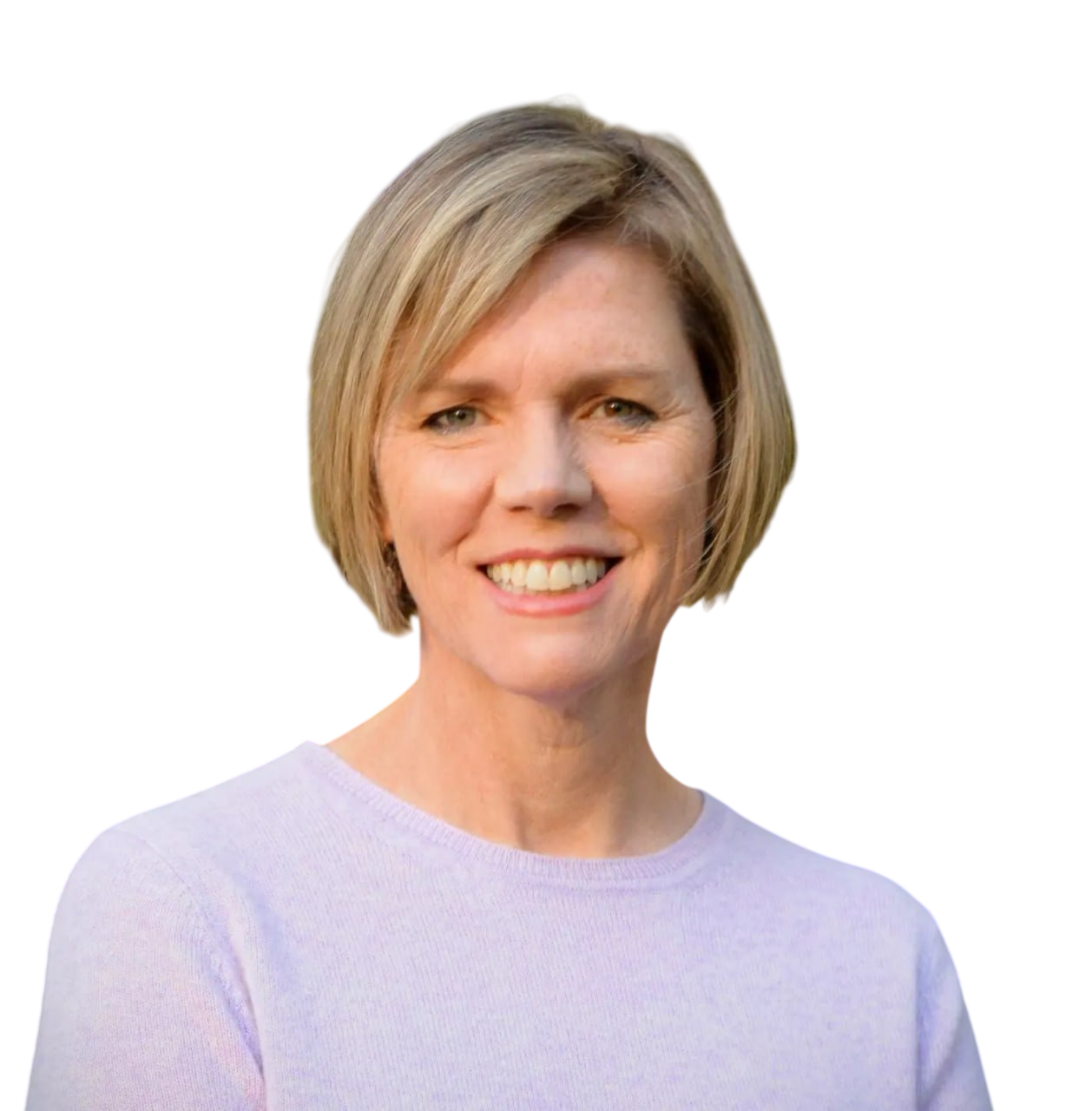 A woman with short blonde hair smiling, wearing a light purple top, with a blurred red and gray background.