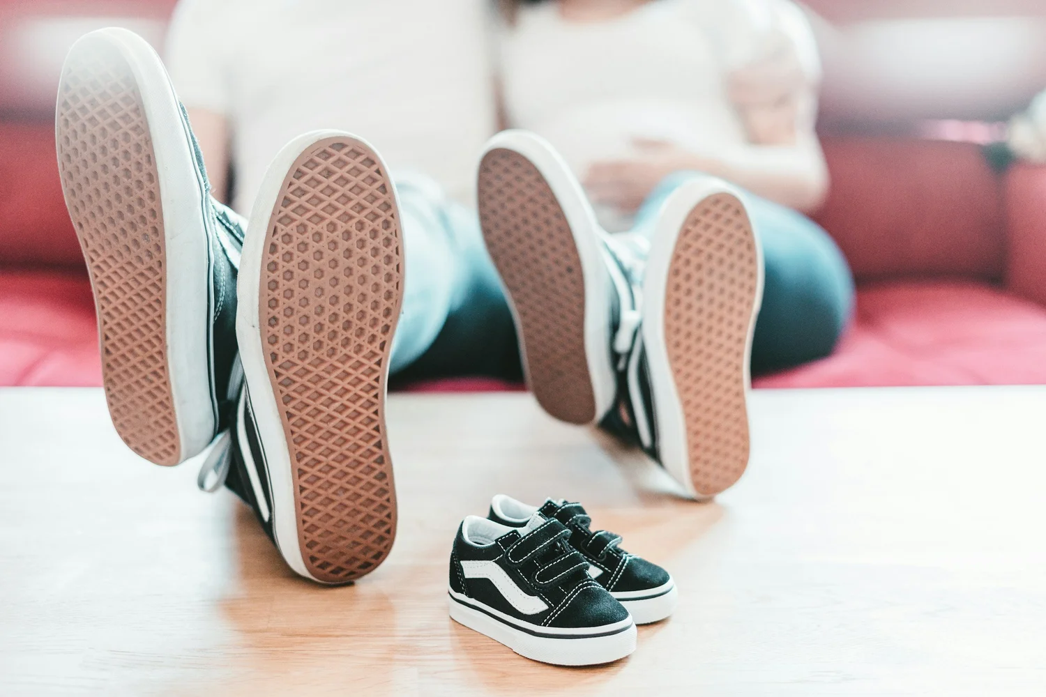 A toddler working on putting on their own shoes
