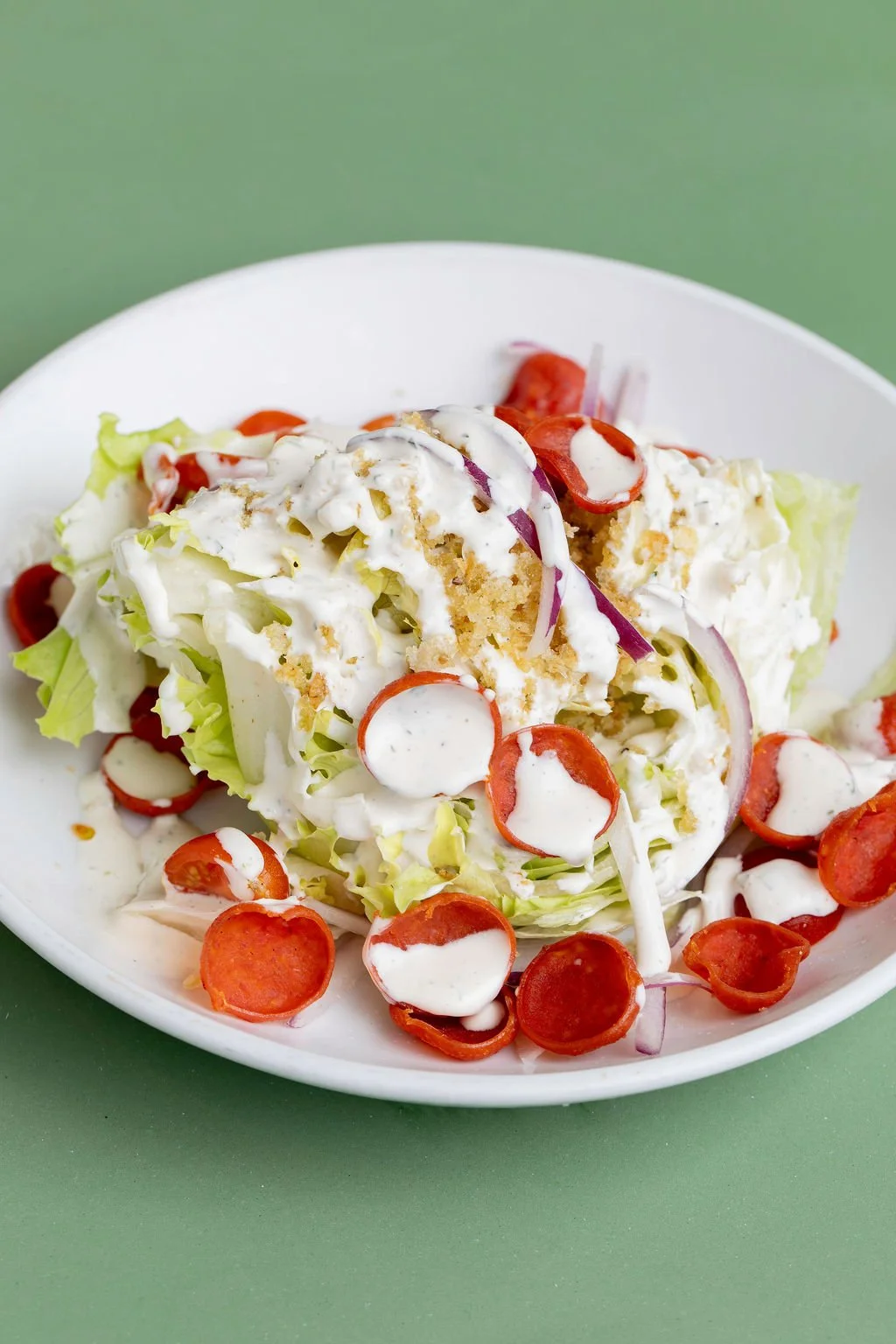 Plate salad/pizza image: Pizza Mamo Pepperoni Wedge Salad with pepperoni and mozzarella