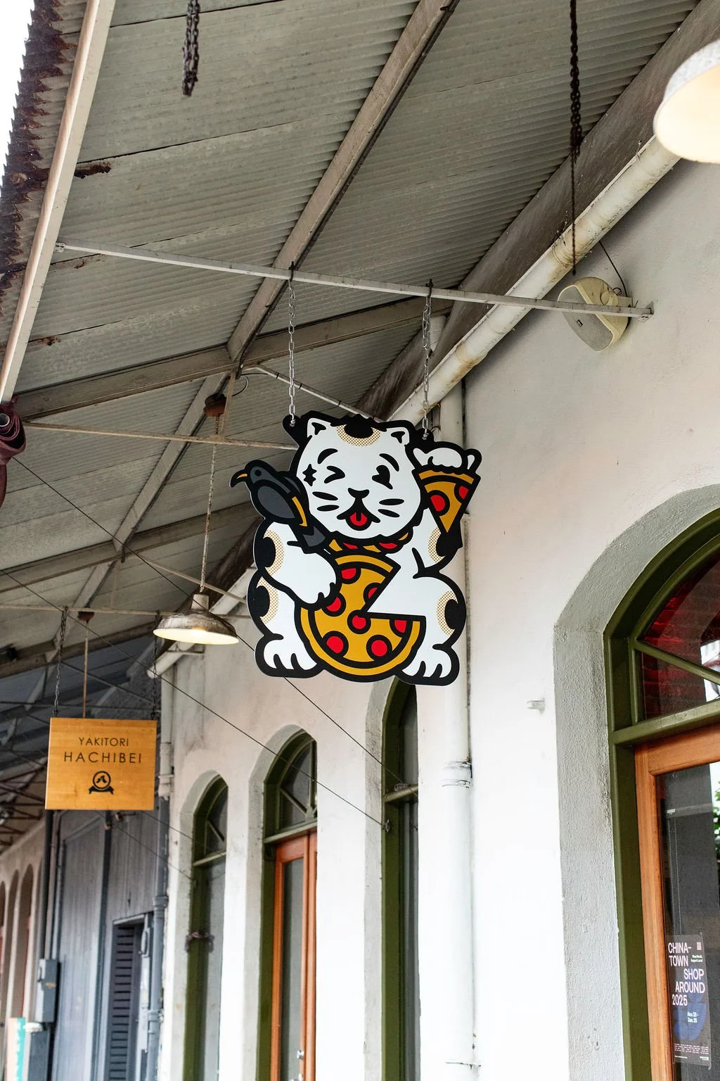 Pizza Mamo Chinatown cat logo signage on the exterior of the Pizza Mamo Honolulu Chinatown location on Oahu