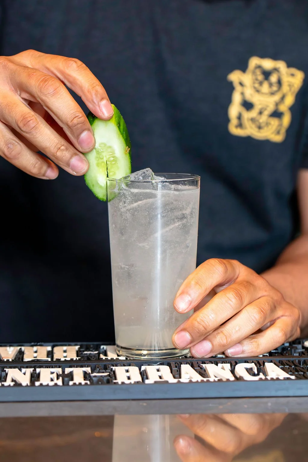Pizza Mamo Barista Mixologist creating a cocktail at the full service bar in Chinatown, Honolulu on Oahu