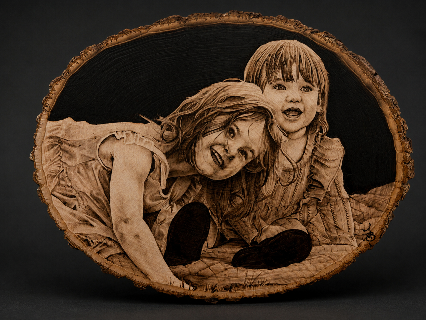 Wooden plaque engraved with a portrait of a woman and a young girl, both smiling and looking at the camera, set against a dark background.