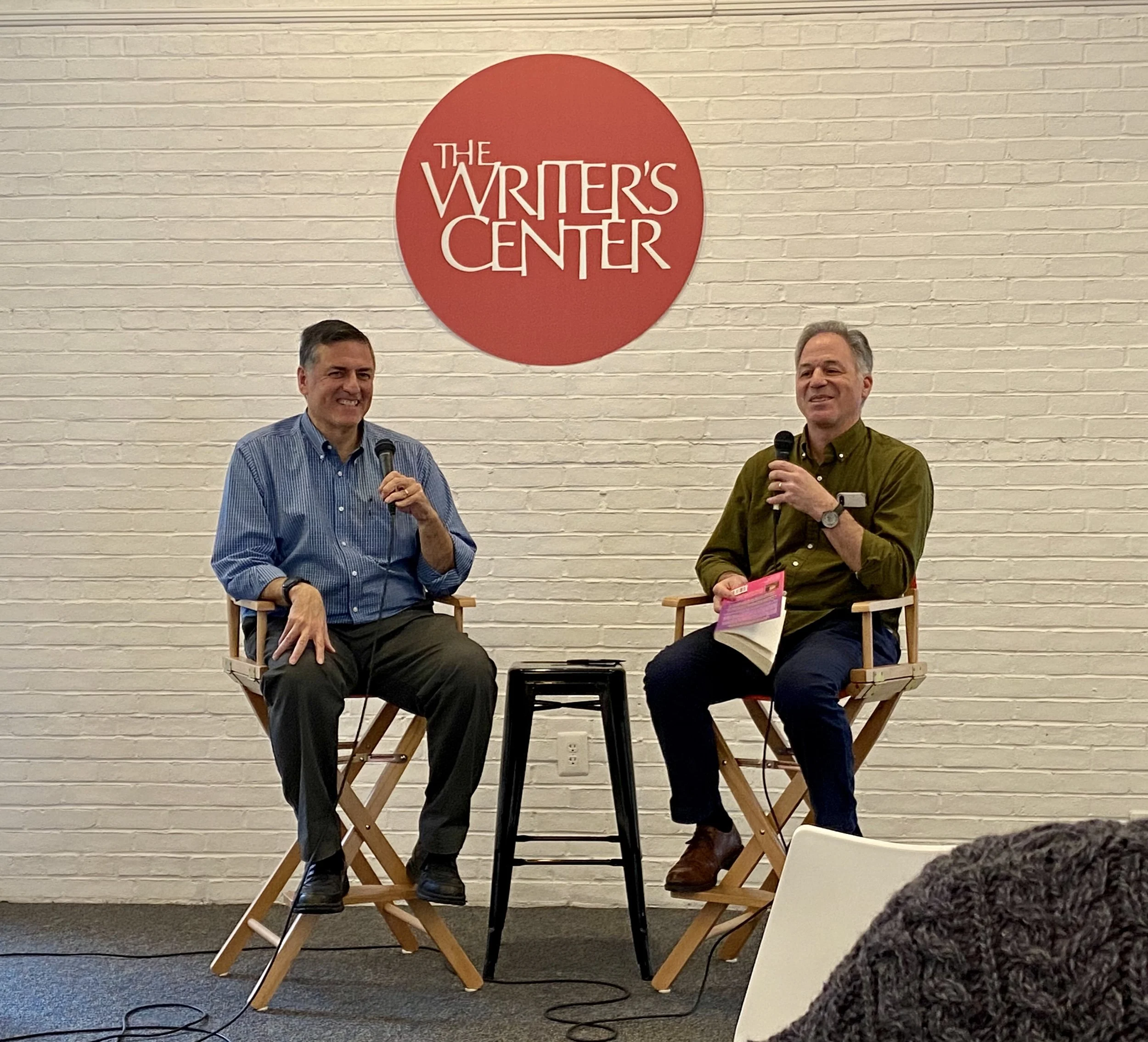 Sergio Troncoso talking with Charles Lane at Bethesda Writer's Center in 2023.