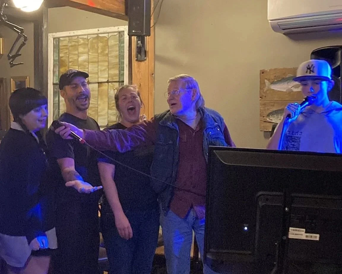 Five people singing karaoke