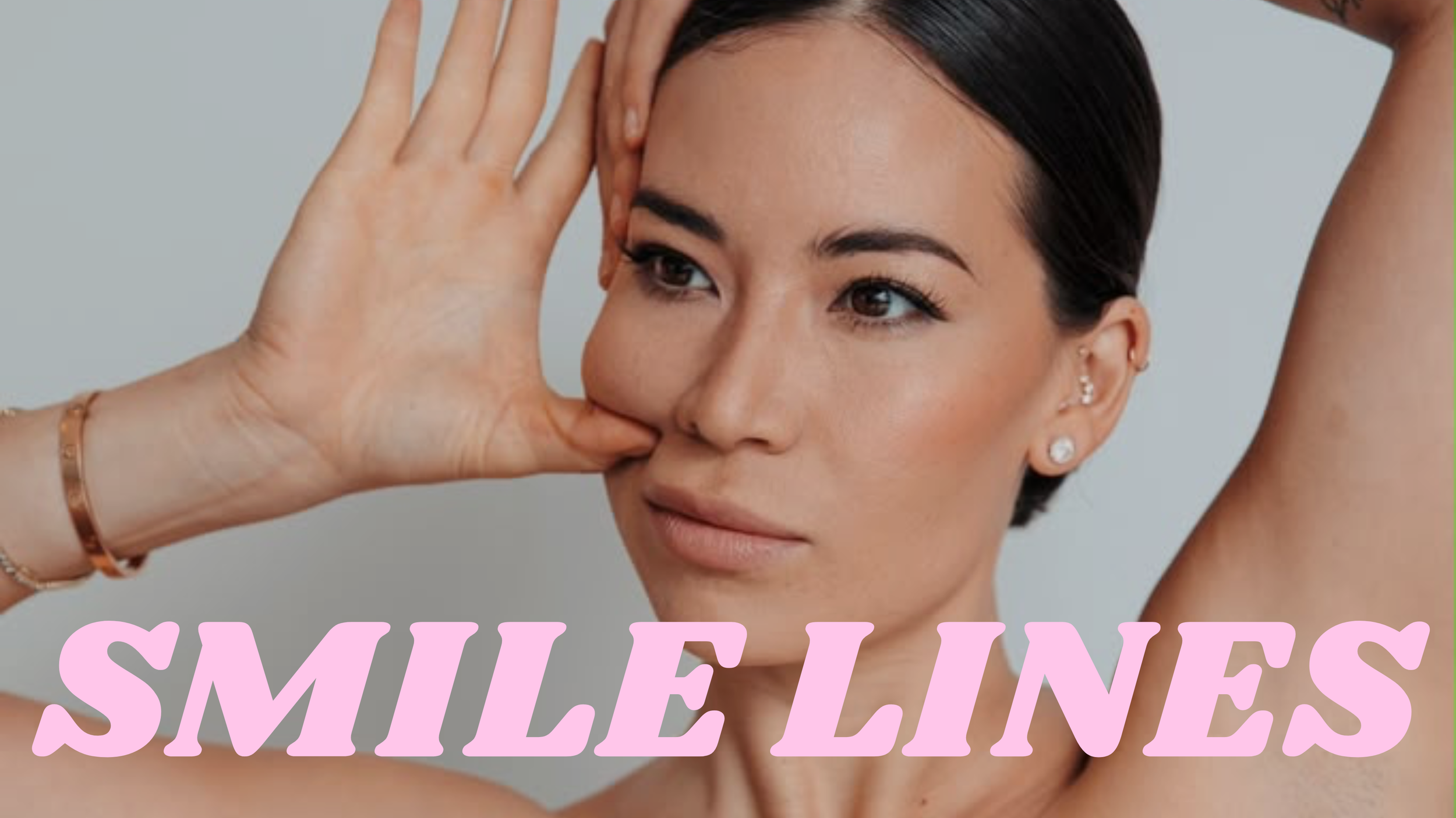 A woman with dark hair and earrings is smiling softly, with her hand near her face, and the text 'SMILE LINES' in pink letters over the bottom part of the image.
