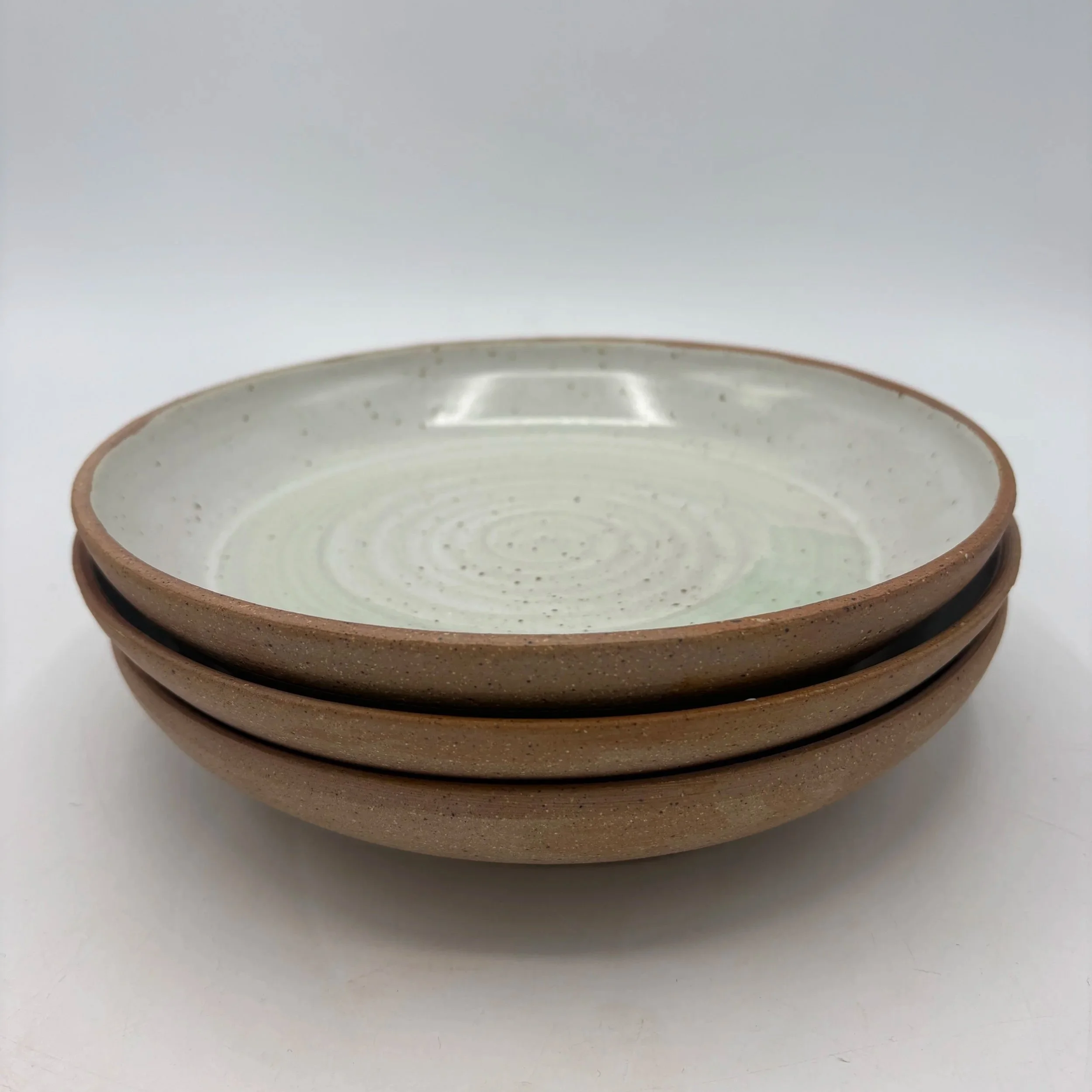 Wheel thrown plates, fired to cone 06 reduction