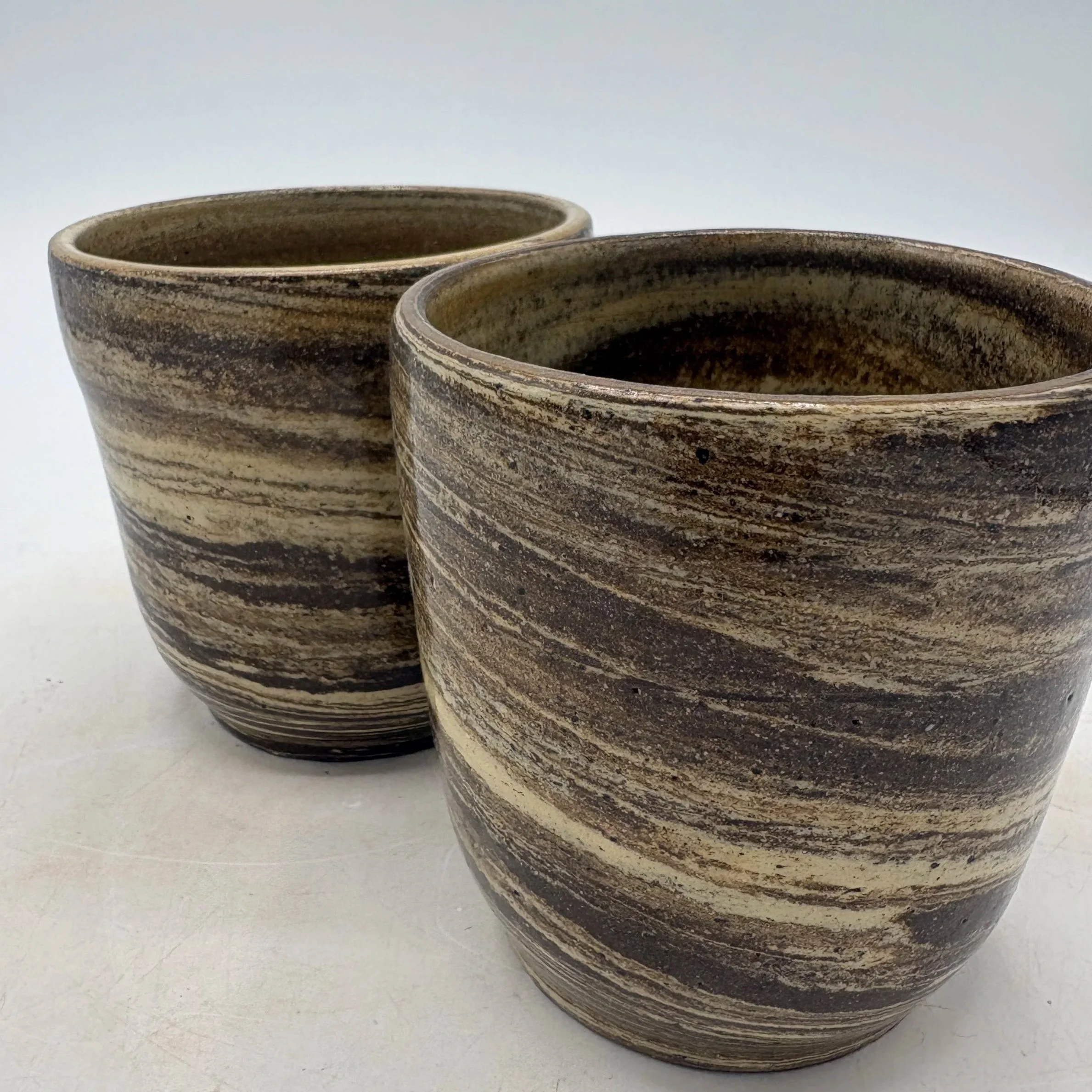 Wheel thrown marbled mugs, fired to cone 06 oxidation