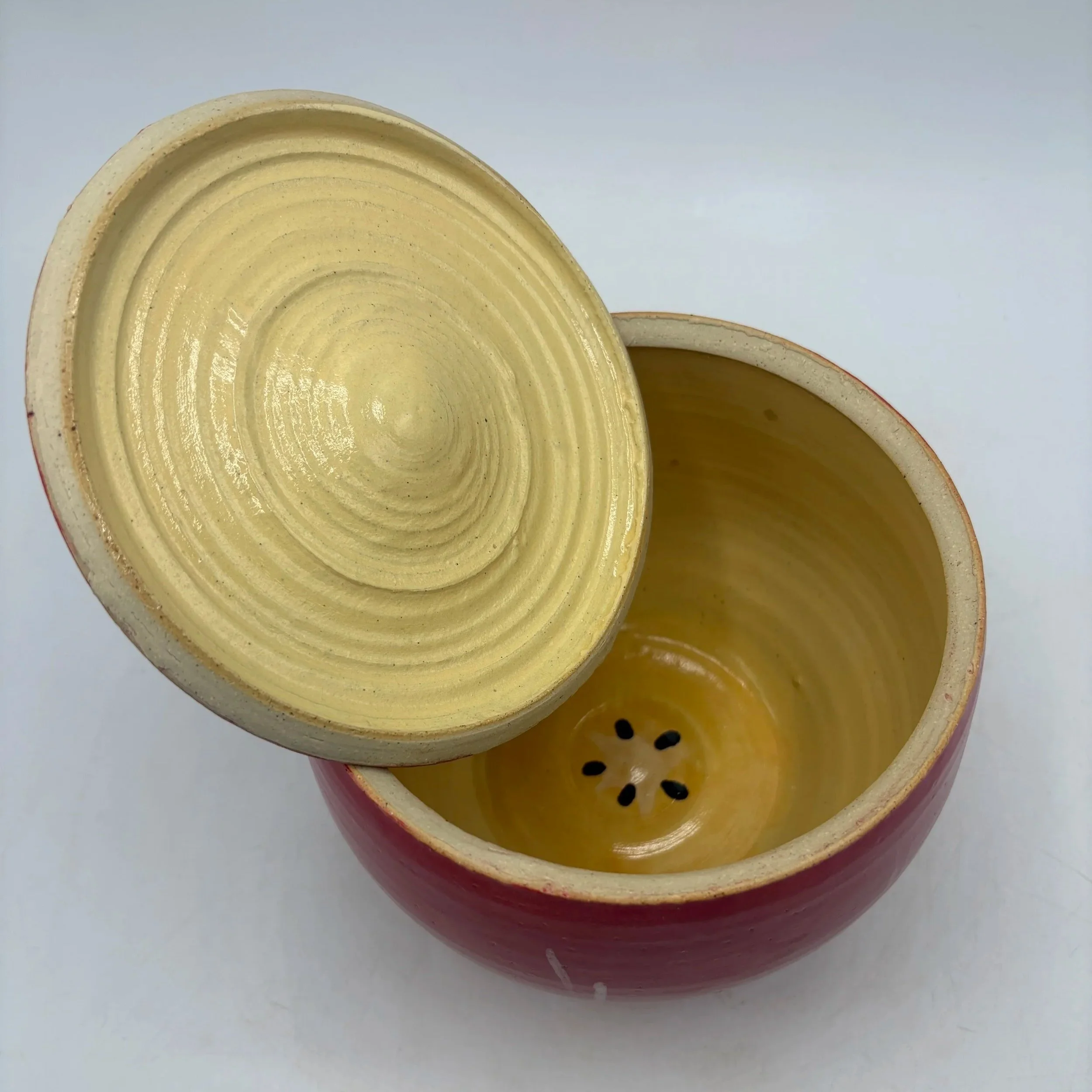Wheel thrown and altered apple jar (open), painted with underglaze, fired to cone 06 oxidation