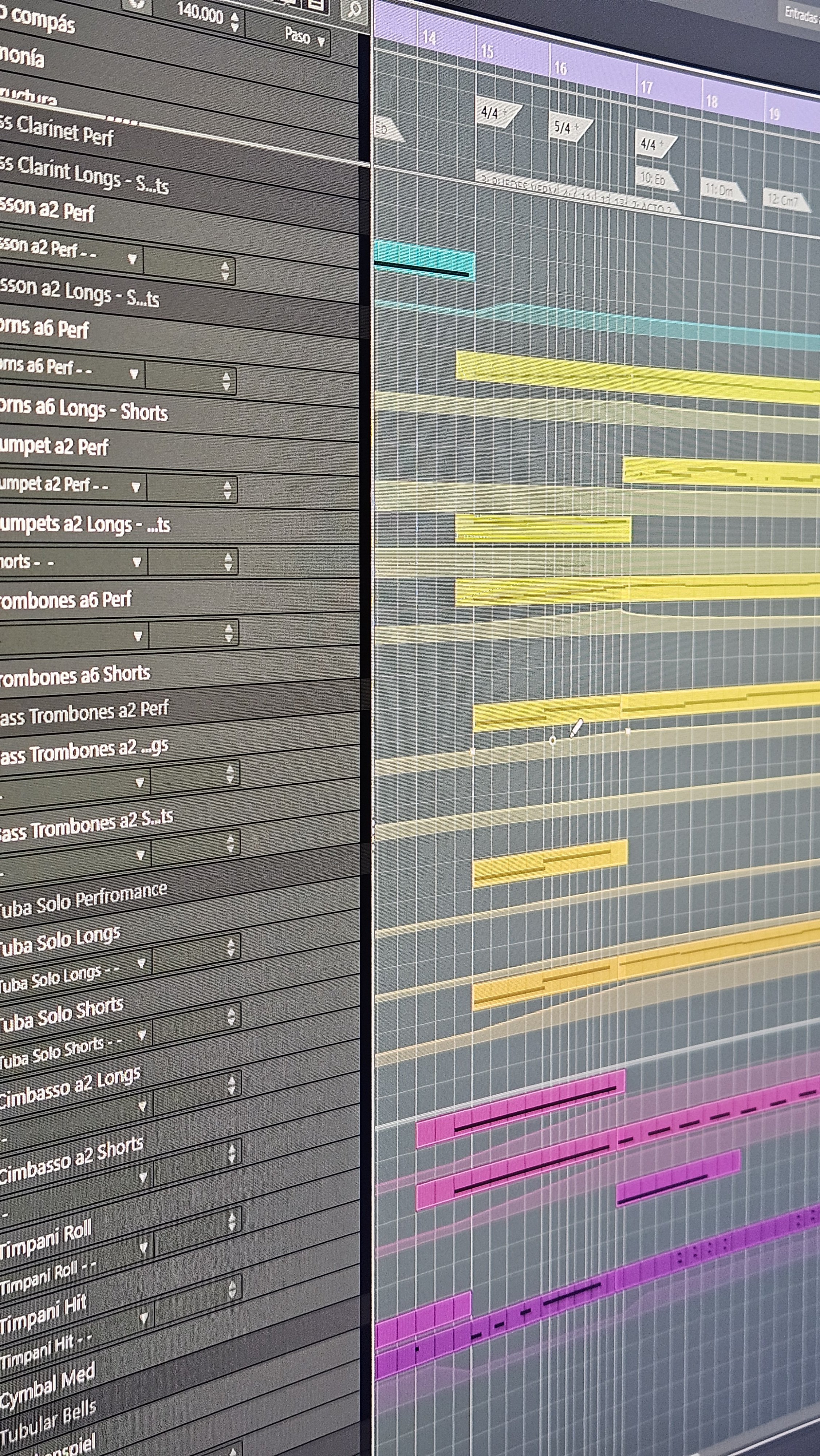 Screenshot of music production software showing a multi-track arrangement with various instrument tracks and color-coded bars indicating different audio clips or MIDI sequences.