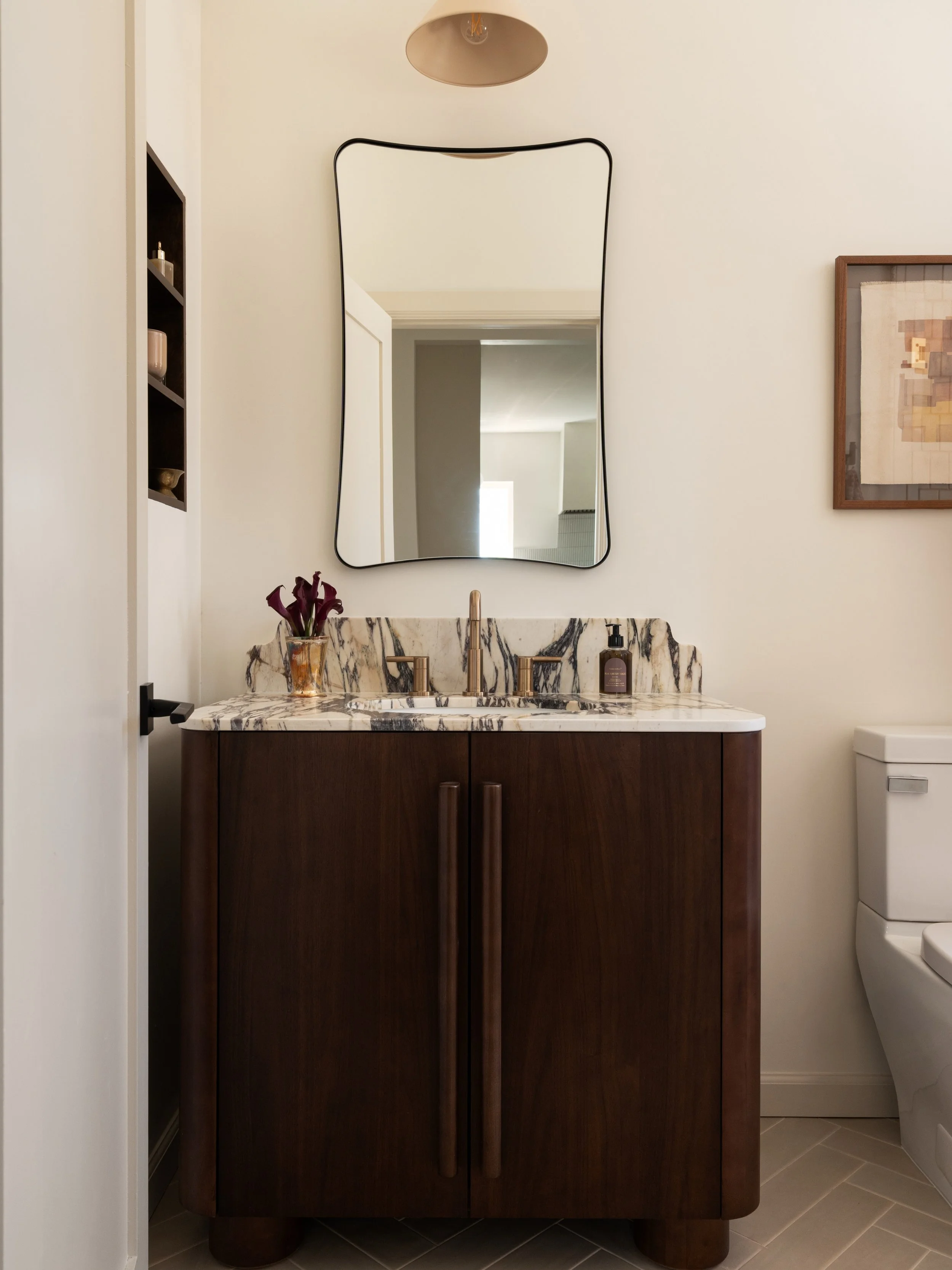 We had the design for this bathroom finalized except for the stone, then went started our search. Our goal was to find a remnant slab that could work here and elsewhere in the home. And we lucked out with a full Calacatta Viola slab! 

Here, it was u